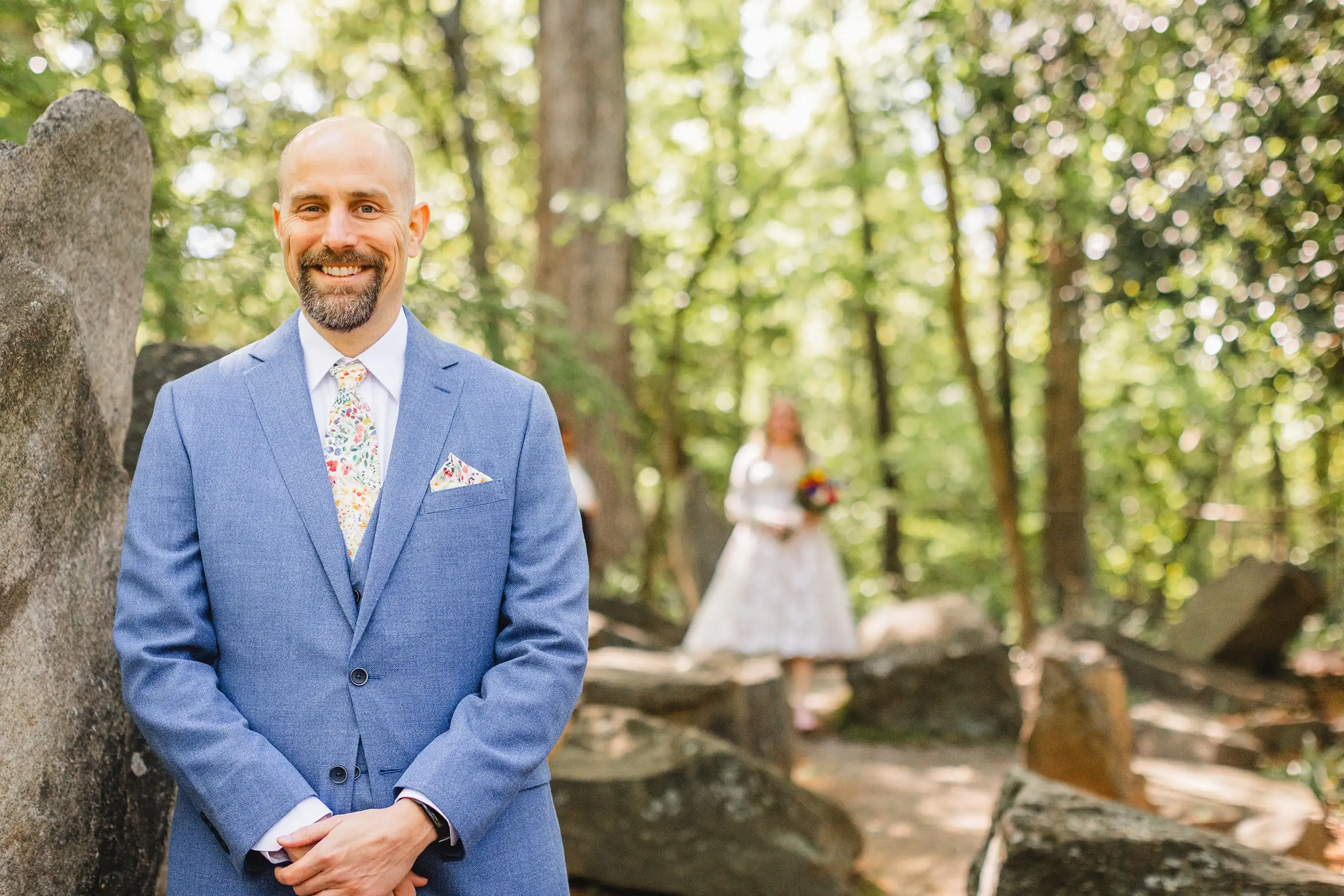 First Look: the groom waiting in the rock garden, before their wedding at Callanwolde Fine Arts Center in Atlanta, GA