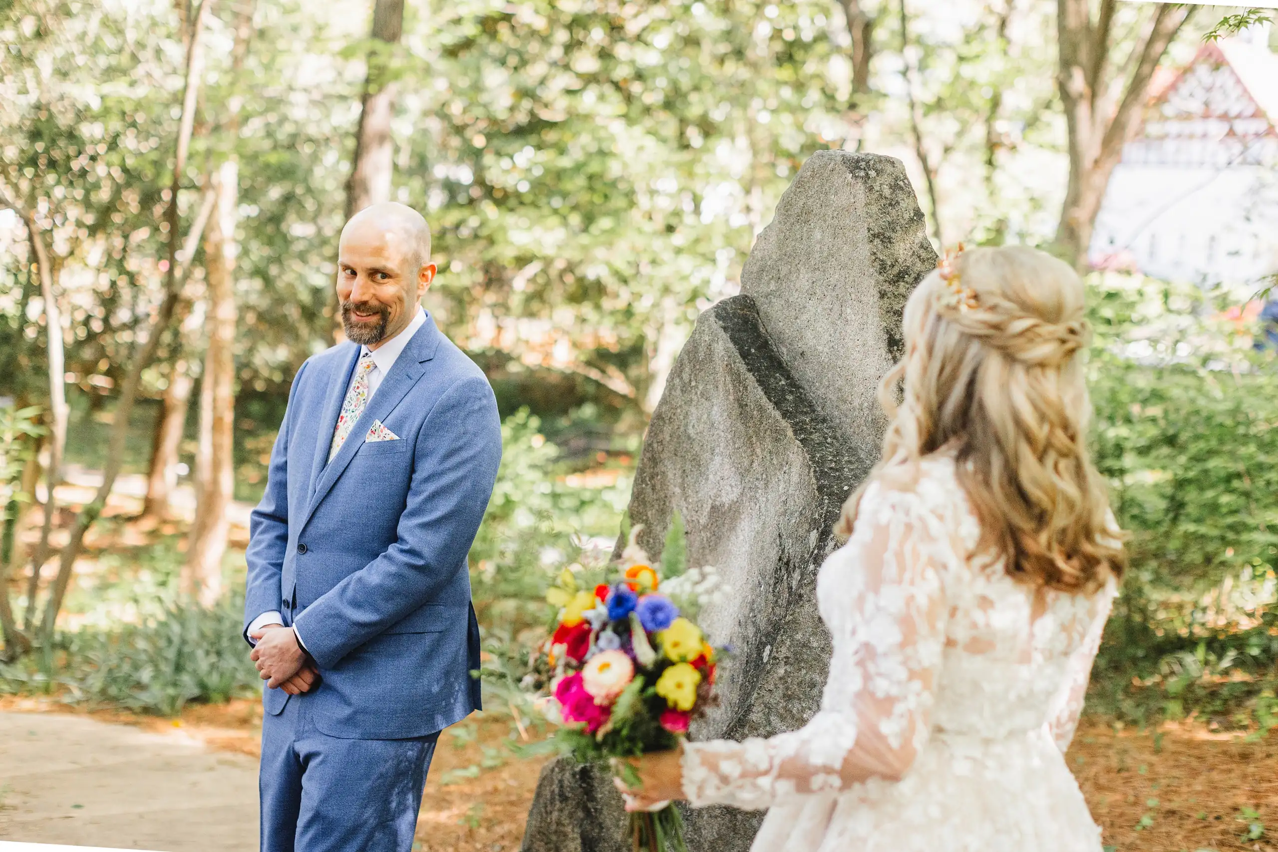 First Look: the groom turning to see her among the stones, before their wedding at Callanwolde Fine Arts Center in Atlanta, GA
