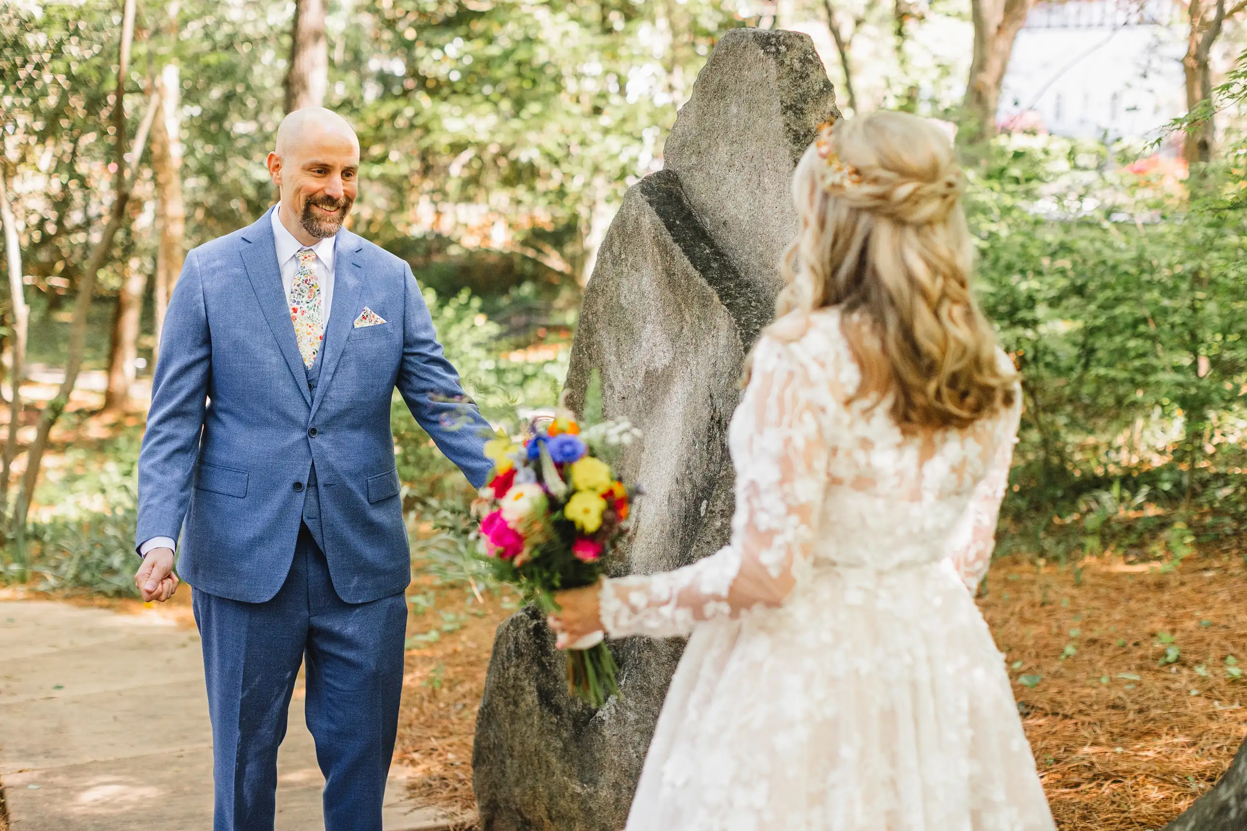 Wedding Formals: the groom leading the bride past the stones, at their wedding at Callanwolde Fine Arts Center in Atlanta, GA