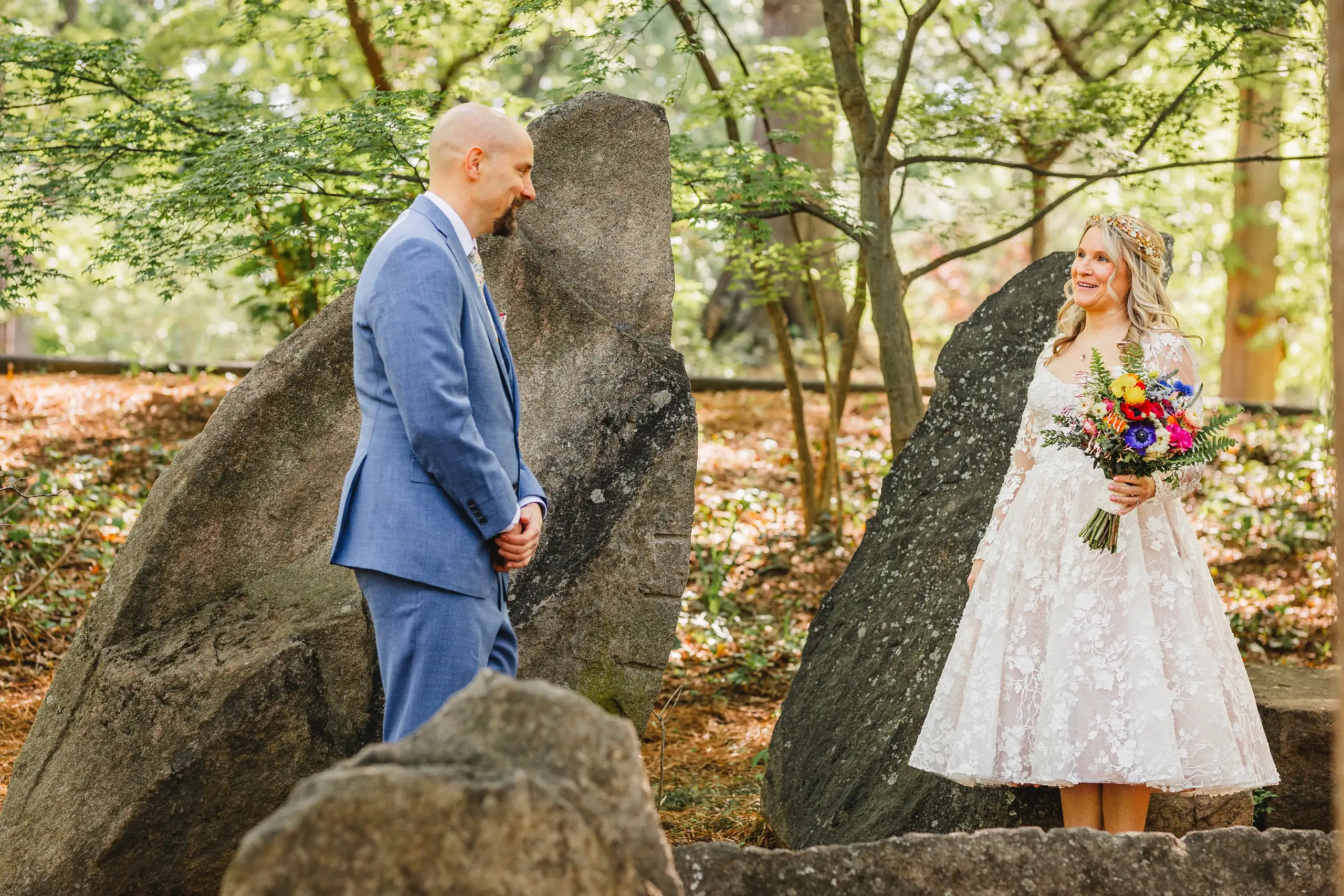 First Look: the couple facing each other among the stones, before their wedding at Callanwolde Fine Arts Center in Atlanta, GA