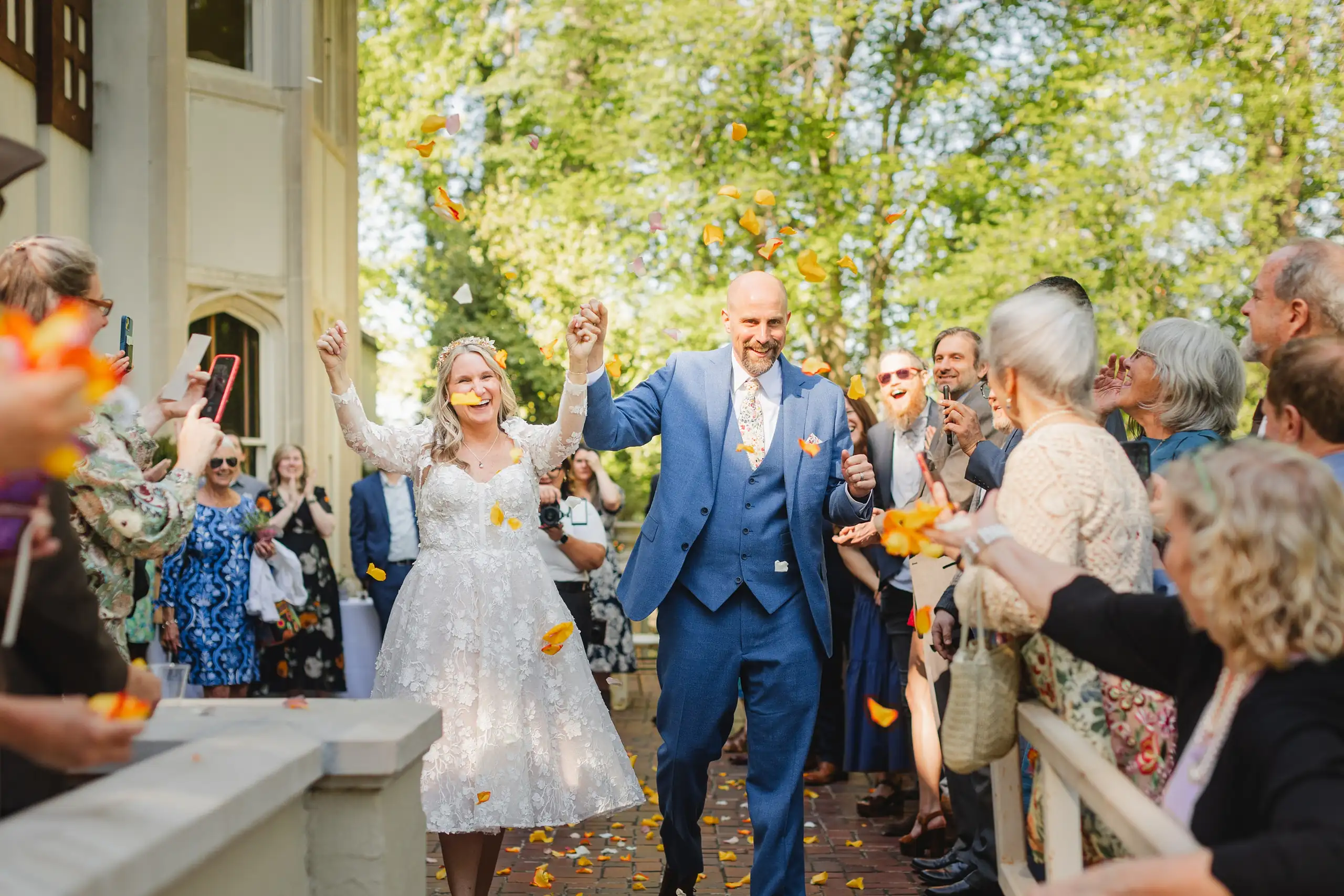Send-Off: the couple leaving through a shower of petals, at their wedding at Callanwolde Fine Arts Center in Atlanta, GA