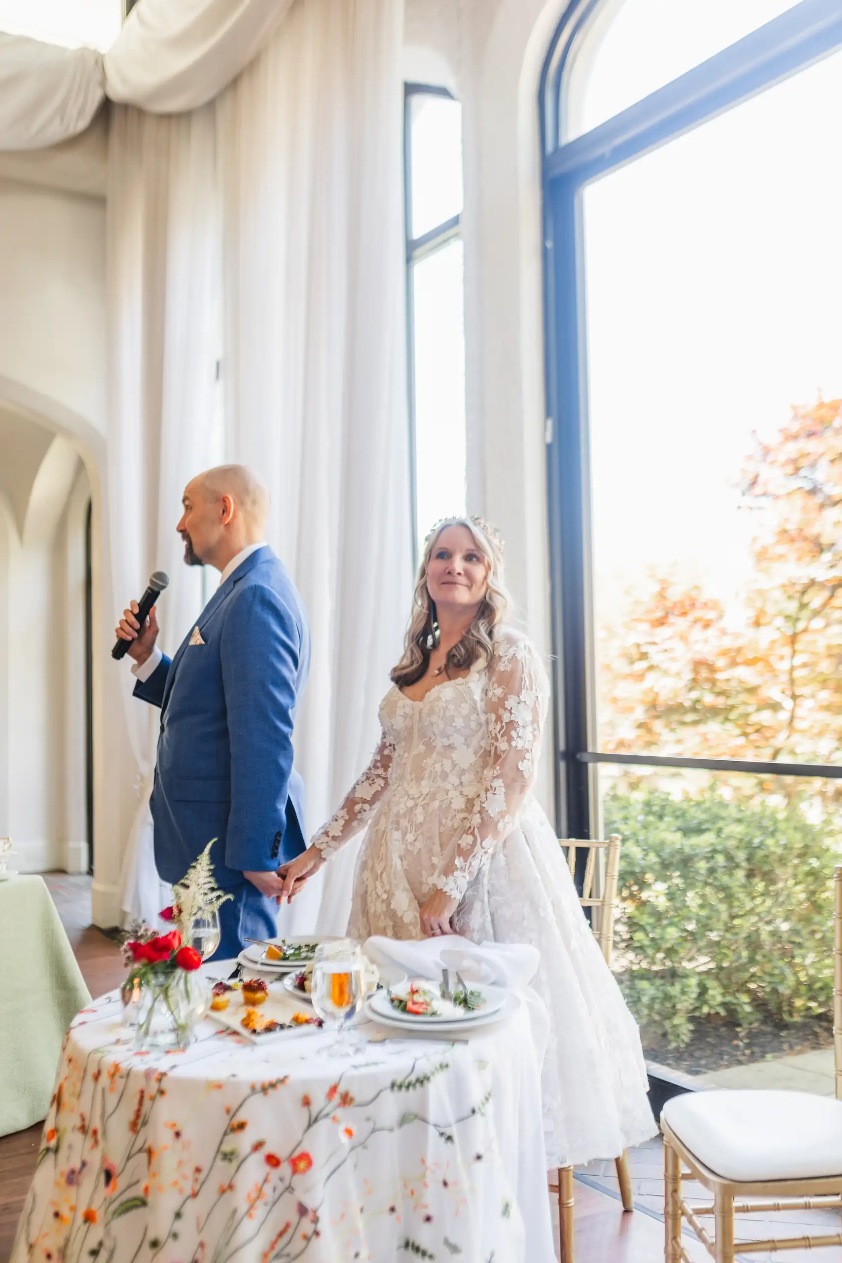 Wedding Reception: the groom speaking beside the cake table, at their wedding at Callanwolde Fine Arts Center in Atlanta, GA