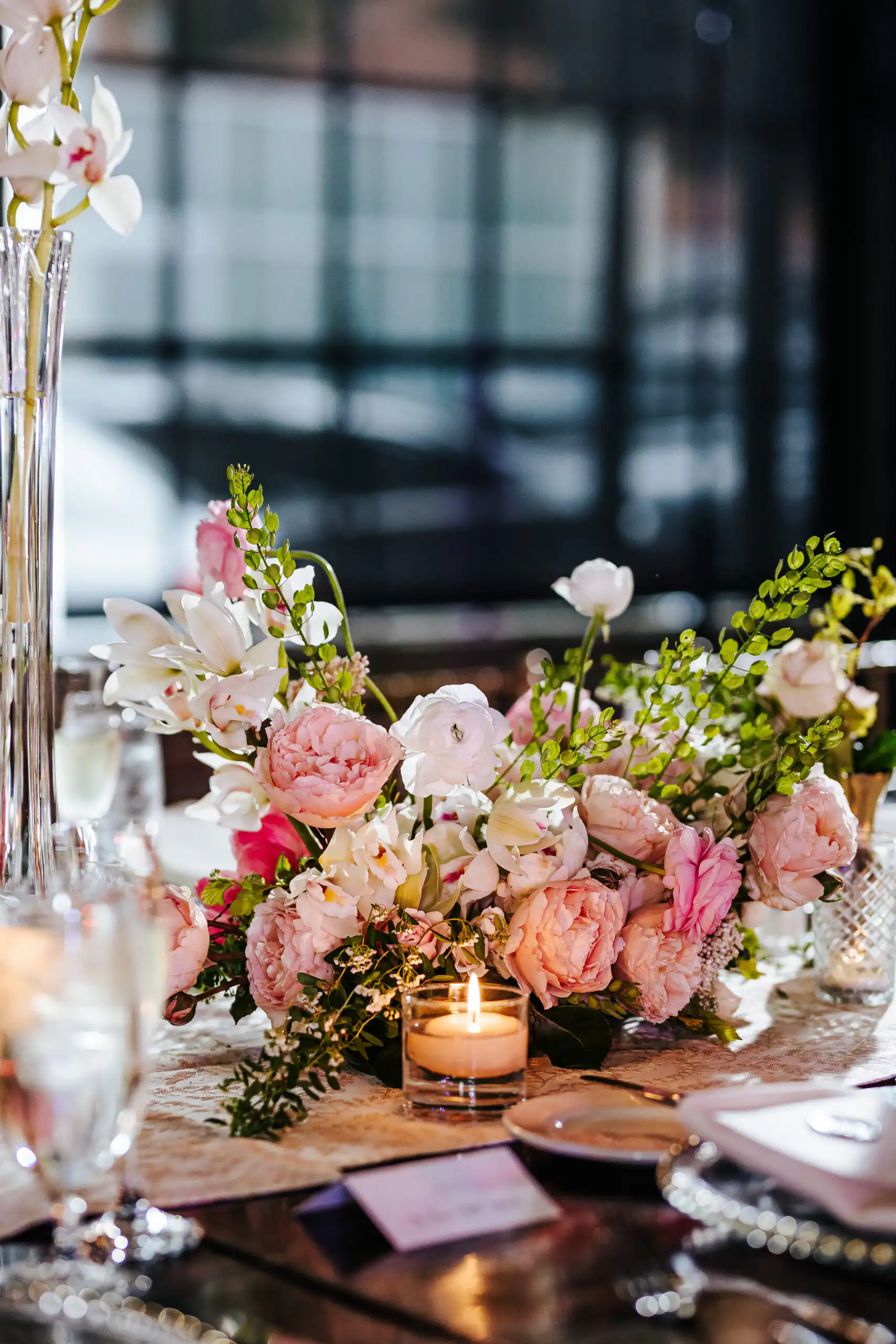 Reception Details: pink flowers in tall glass vases down the table, at a wedding at Summerour Studio in Atlanta, GA