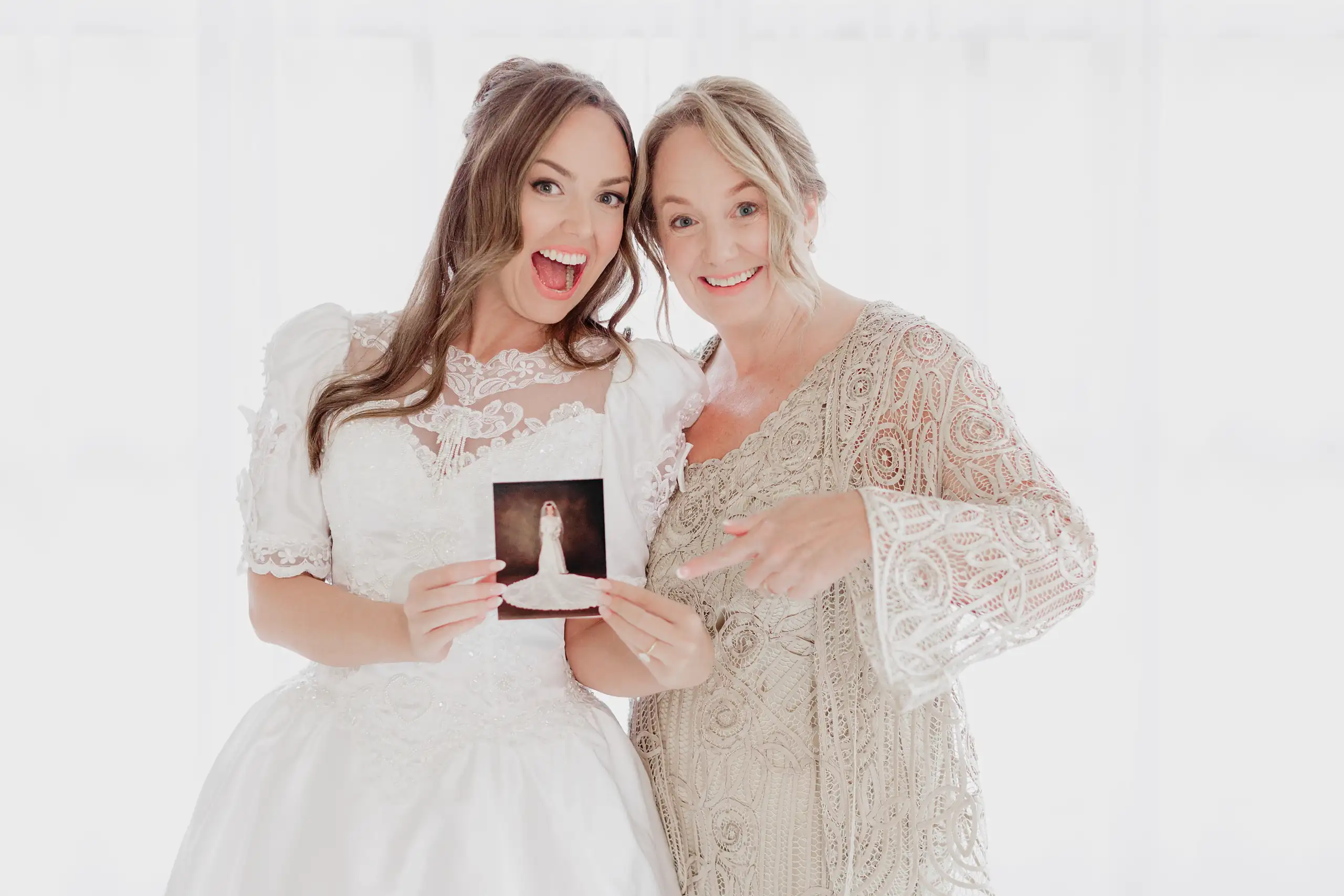 Bridal Portraits: the two of them laughing over an old photograph, during her bridal portrait session