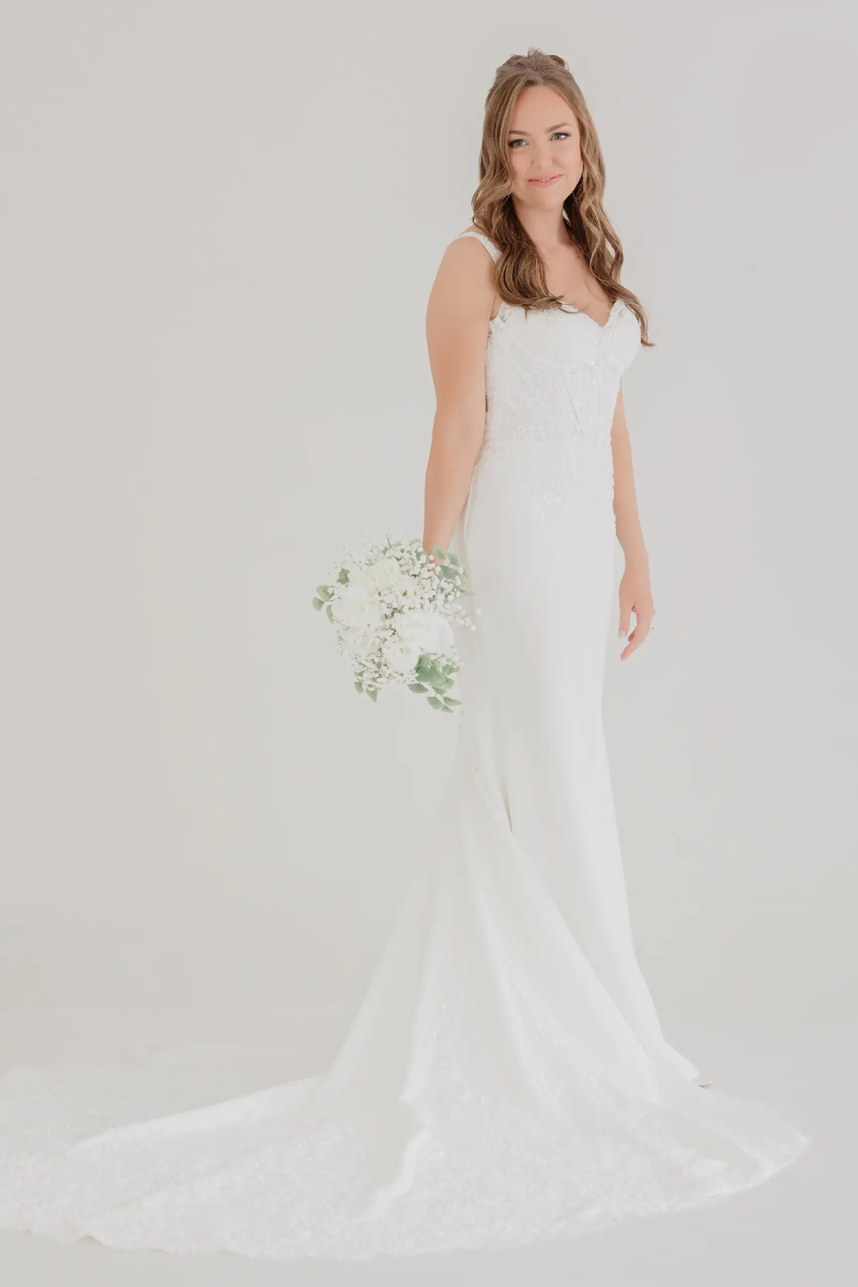 Bridal Portraits: the bride standing full length with her bouquet, during her bridal portrait session
