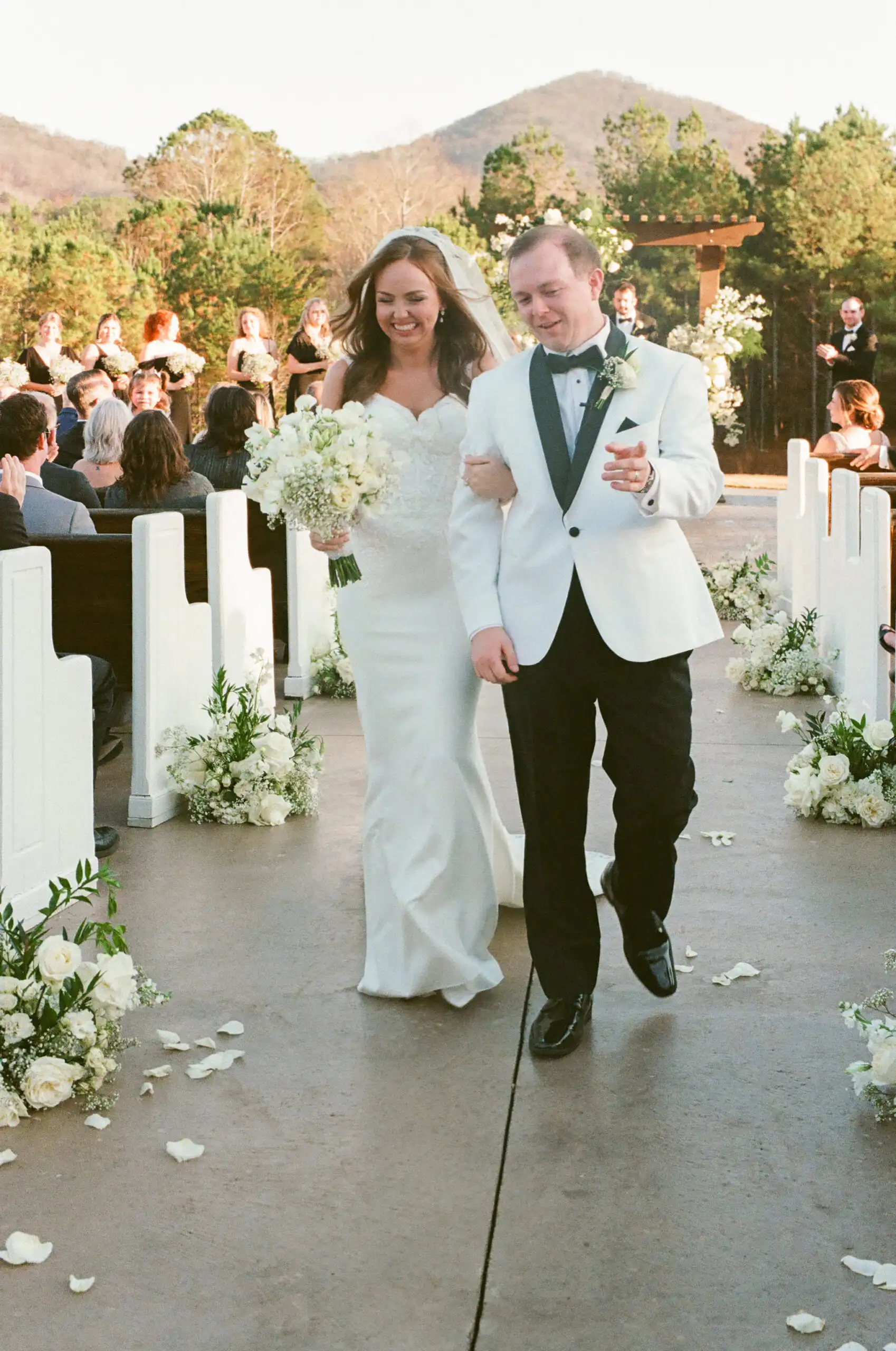Bride and groom walking back up the aisle after their wedding ceremony, shot on 35mm film