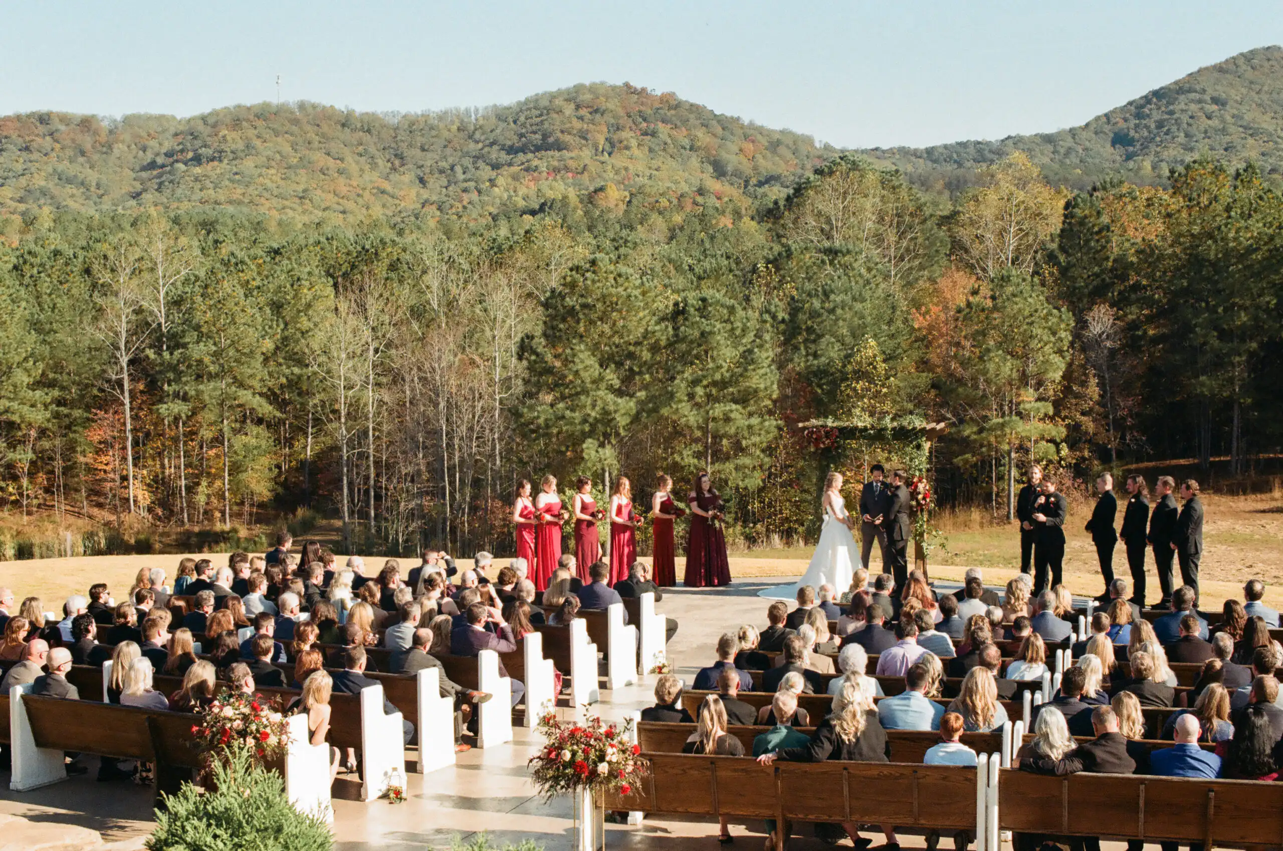 Wedding ceremony on the tiered lawn with the mountains behind, shot on 35mm film at The Venue at Sharp Mountain in North Georgia