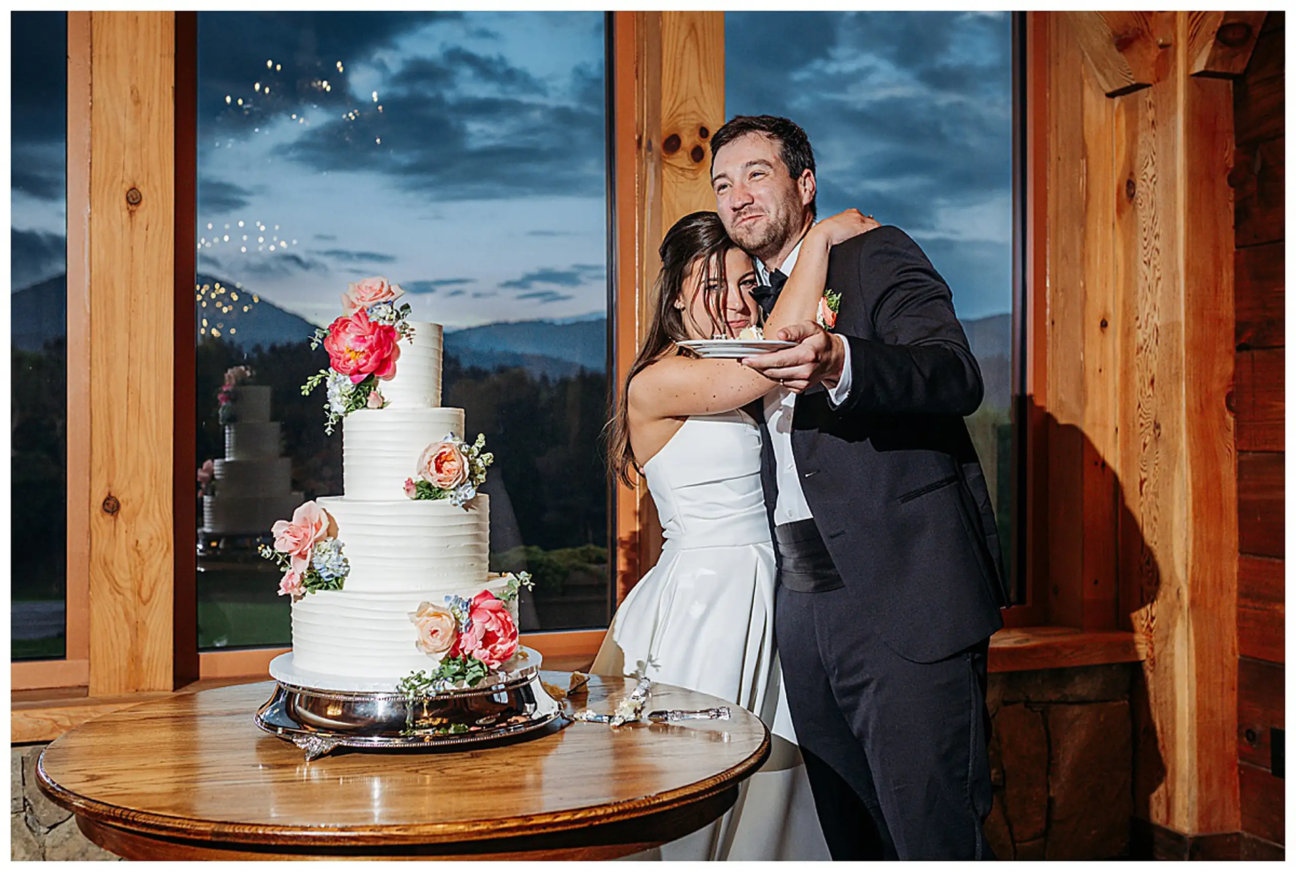 Cake Cutting: cutting the cake against the window as the light goes, at their wedding at The Venue at Sharp Mountain in Jasper, GA
