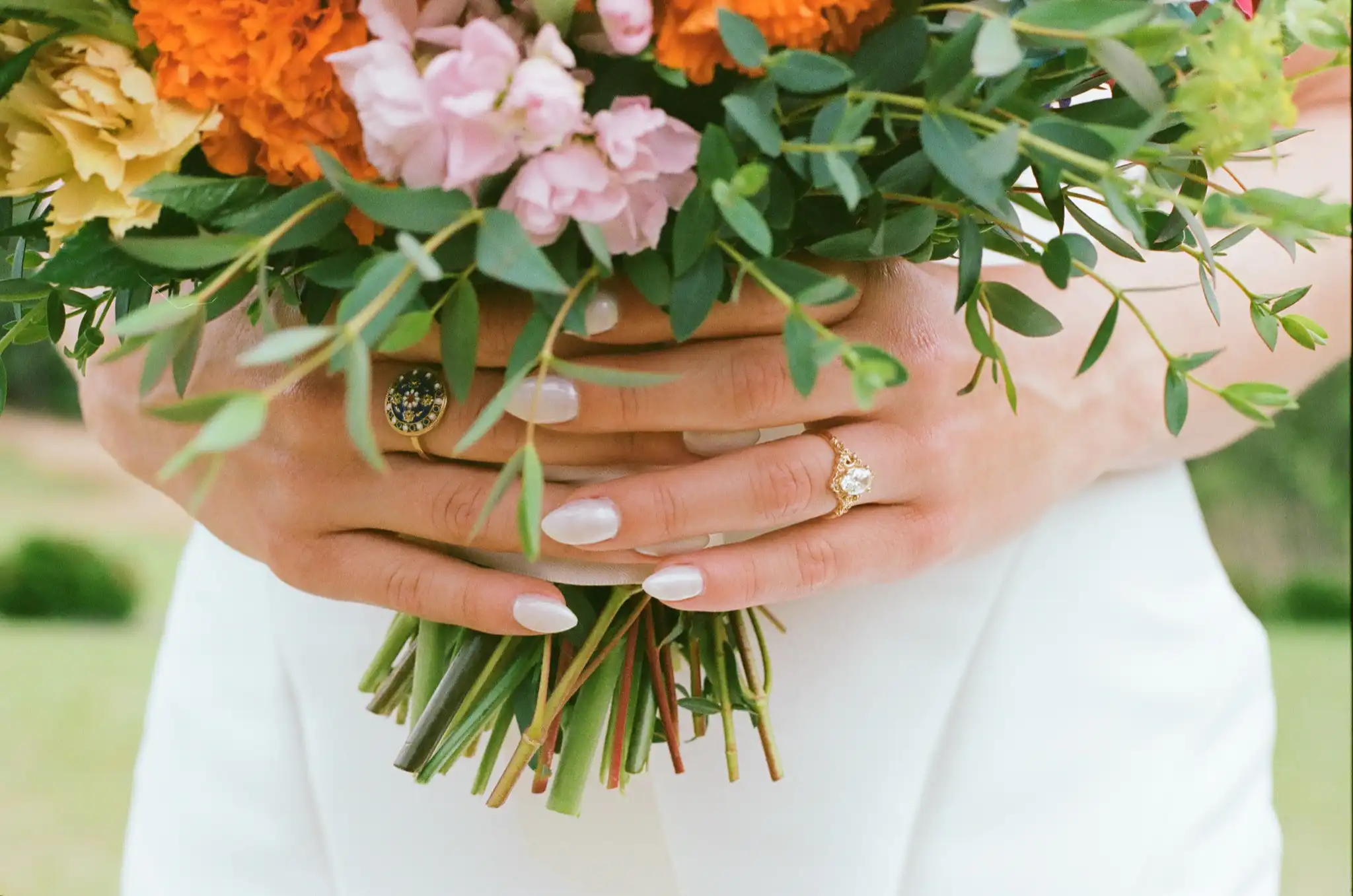 Bride's hands and engagement ring around a bright garden bouquet, shot on 35mm film at The Venue at Sharp Mountain in Jasper, Georgia