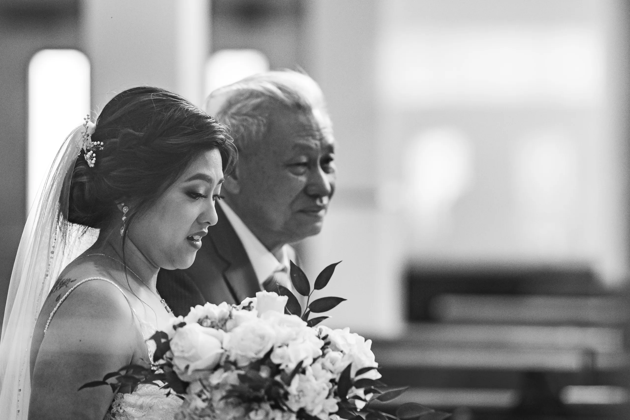 Wedding Ceremony: the bride with her father before the processional, in black and white at their wedding at Holy Cross Catholic Church in Atlanta, GA
