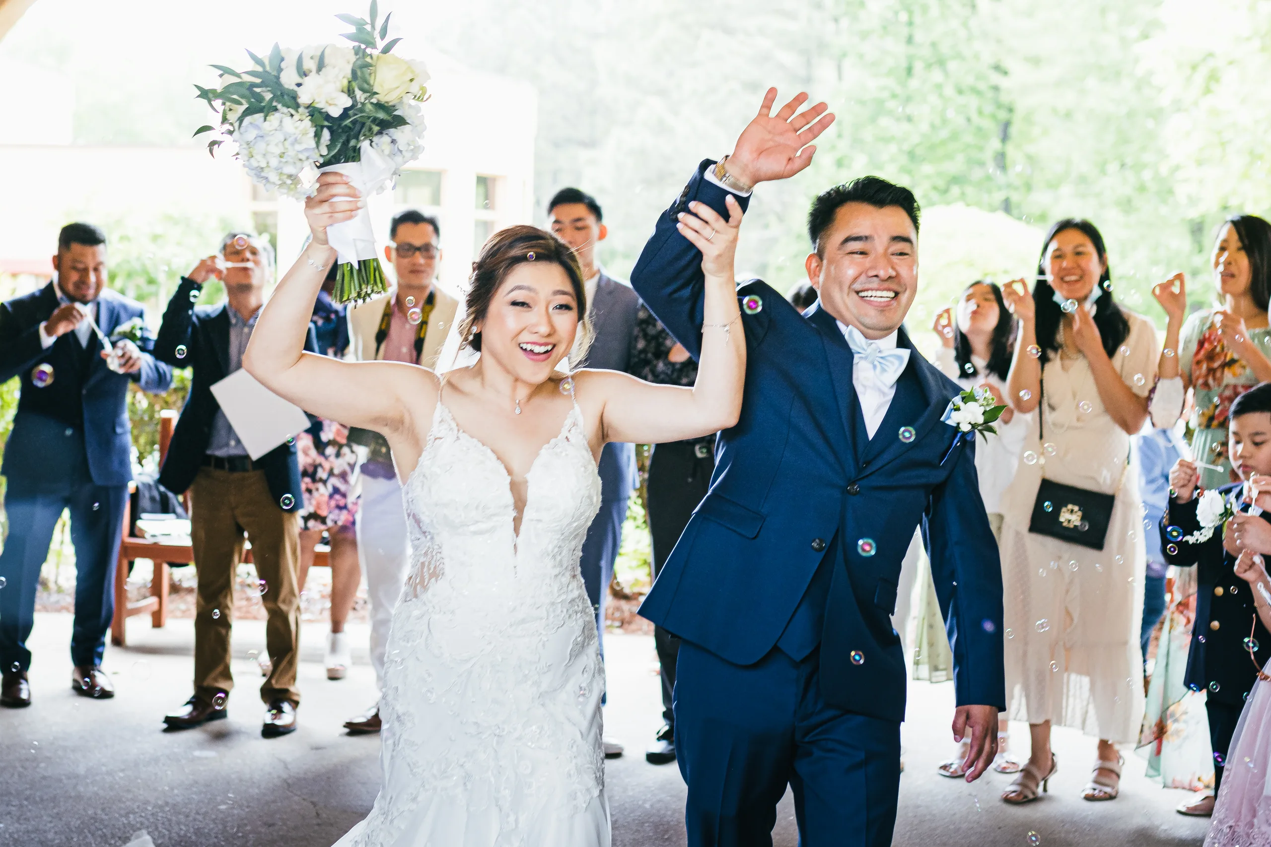 Wedding Ceremony: celebrating with their guests after the ceremony at their wedding at Holy Cross Catholic Church in Atlanta, GA