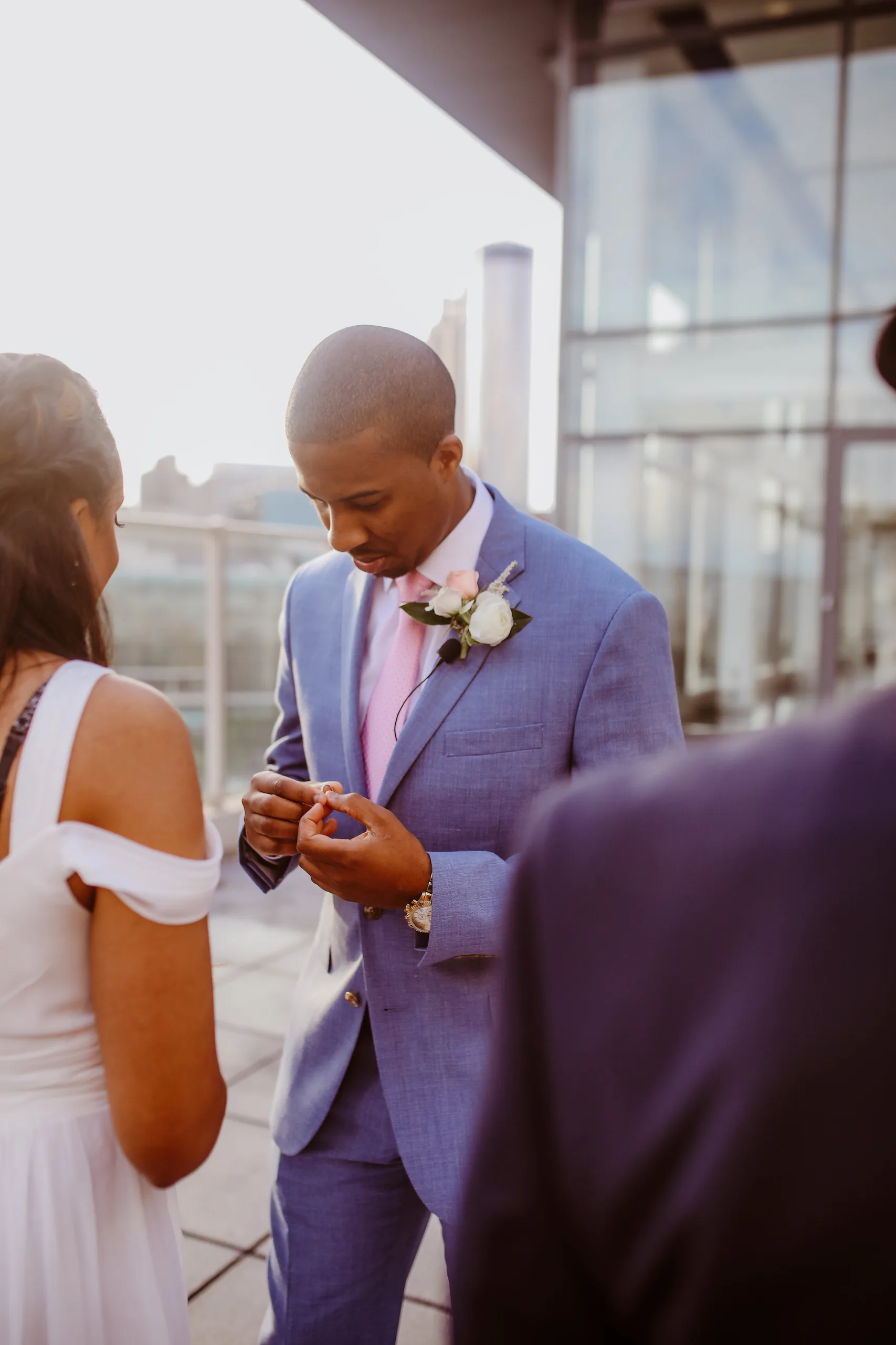 Wedding Ceremony: the groom sliding her ring on, at their elopement at Ventanas in Atlanta, GA