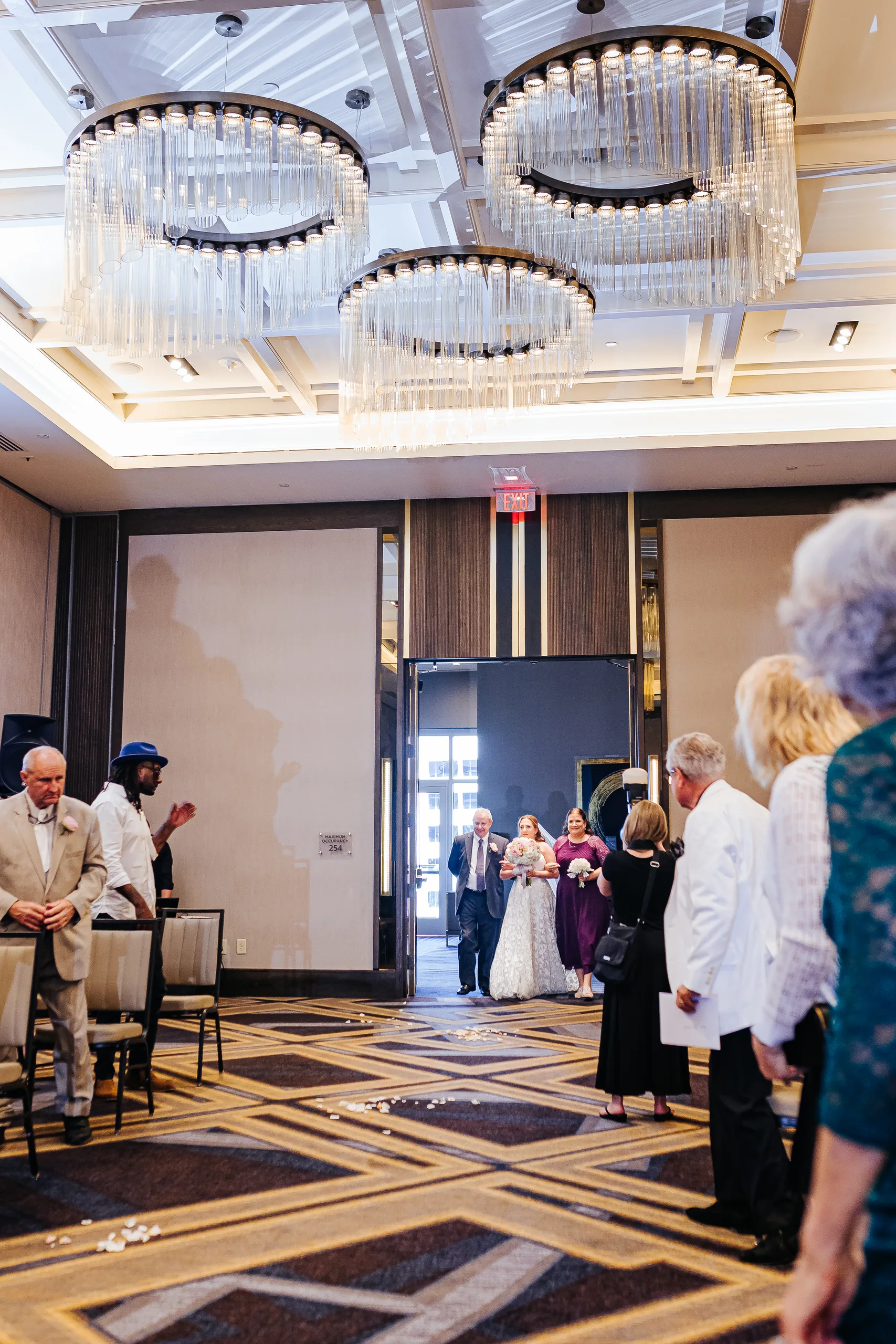 Wedding Ceremony: the bride walking down the aisle in the ballroom at their wedding at the Omni Hotel at The Battery in Atlanta, GA