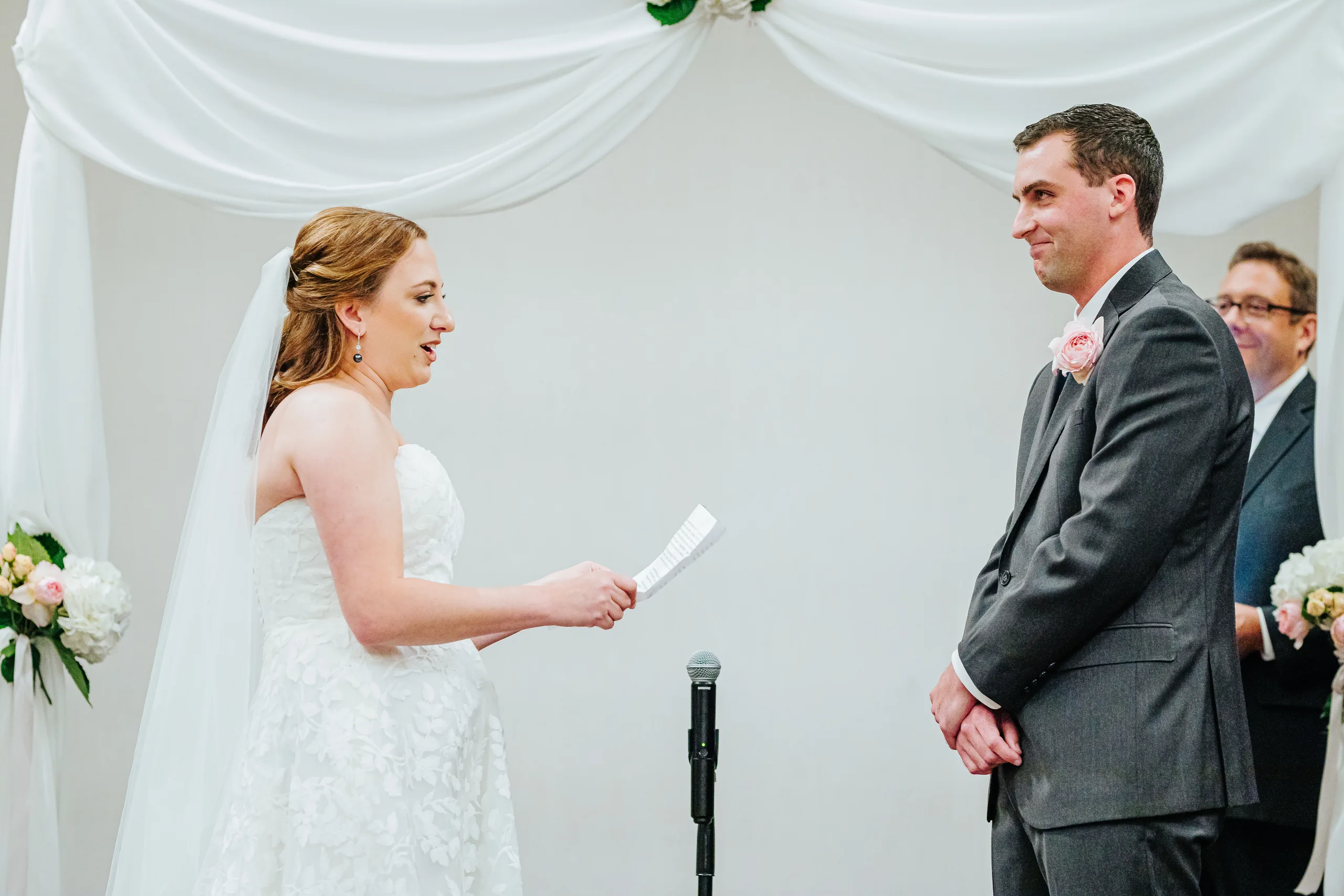 Wedding Ceremony: the bride reading her vows at their wedding at the Omni Hotel at The Battery in Atlanta, GA