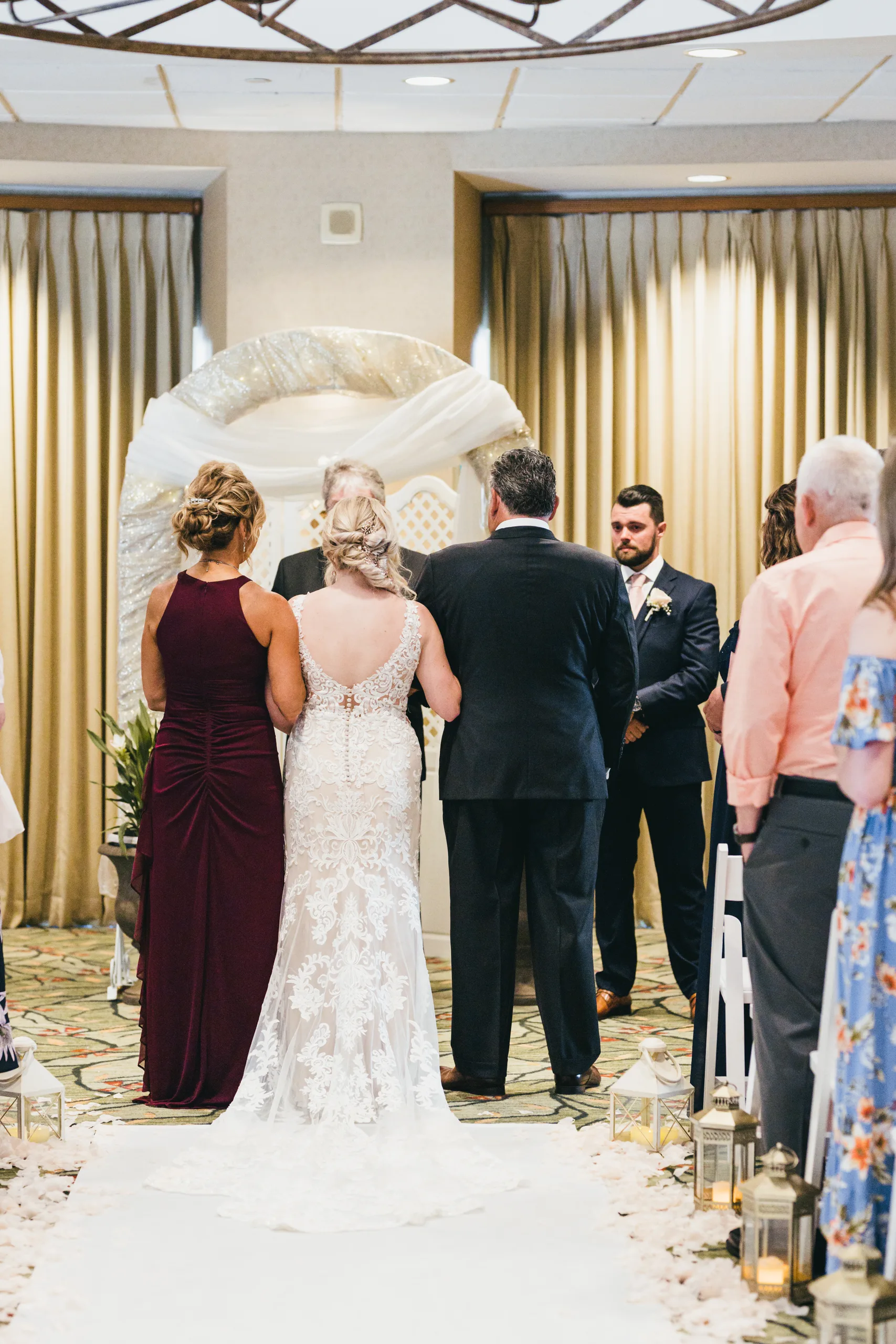 Wedding Ceremony: the bride walking down the aisle toward the groom, at their wedding at Atlanta Evergreen Lakeside Resort in Stone Mountain, GA