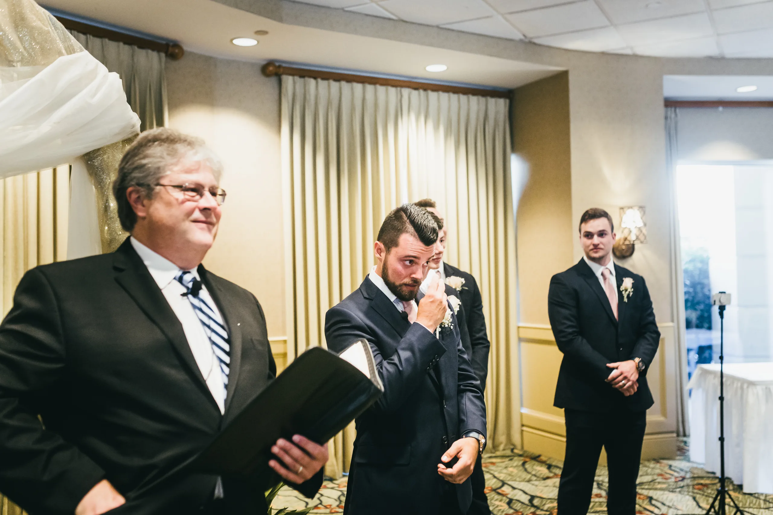 Wedding Ceremony: the groom wiping away tears as she walks in, at their wedding at Atlanta Evergreen Lakeside Resort in Stone Mountain, GA