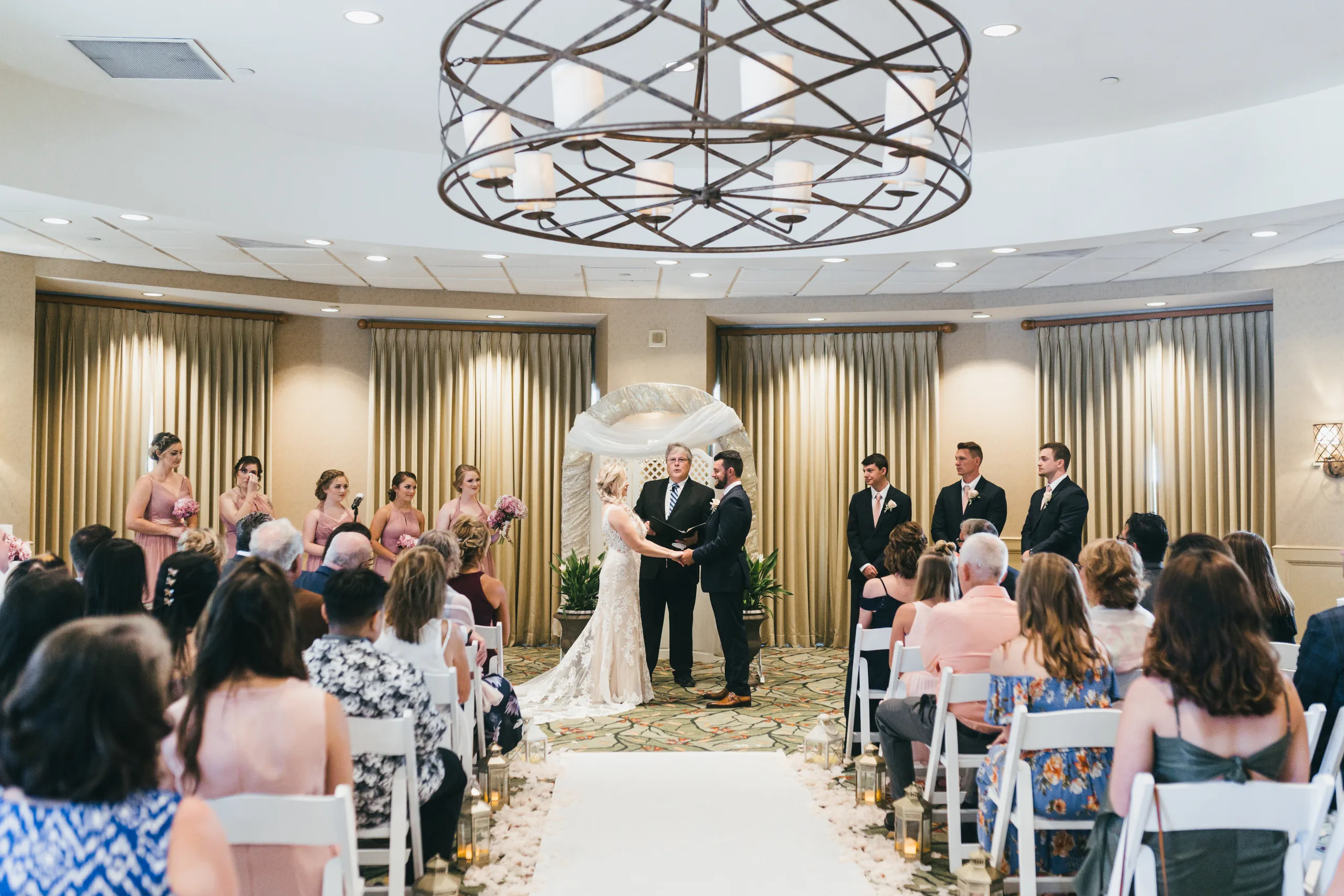 Wedding Ceremony: exchanging vows under the chandelier, at their wedding at Atlanta Evergreen Lakeside Resort in Stone Mountain, GA