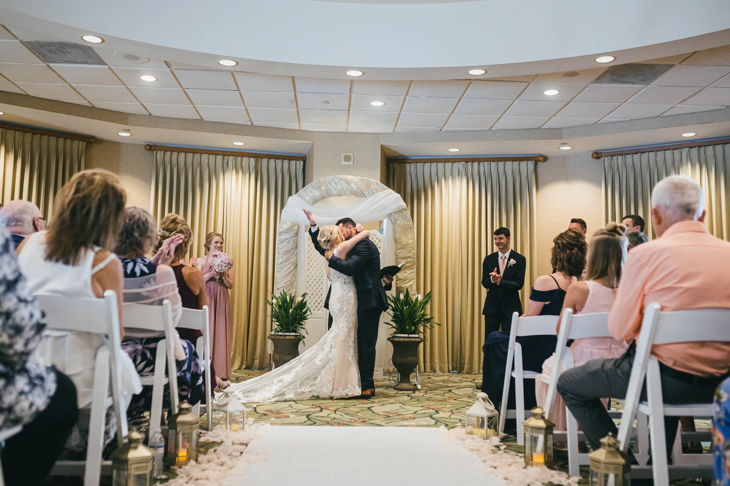 Wedding Ceremony: the first kiss at the white arch, at their wedding at Atlanta Evergreen Lakeside Resort in Stone Mountain, GA