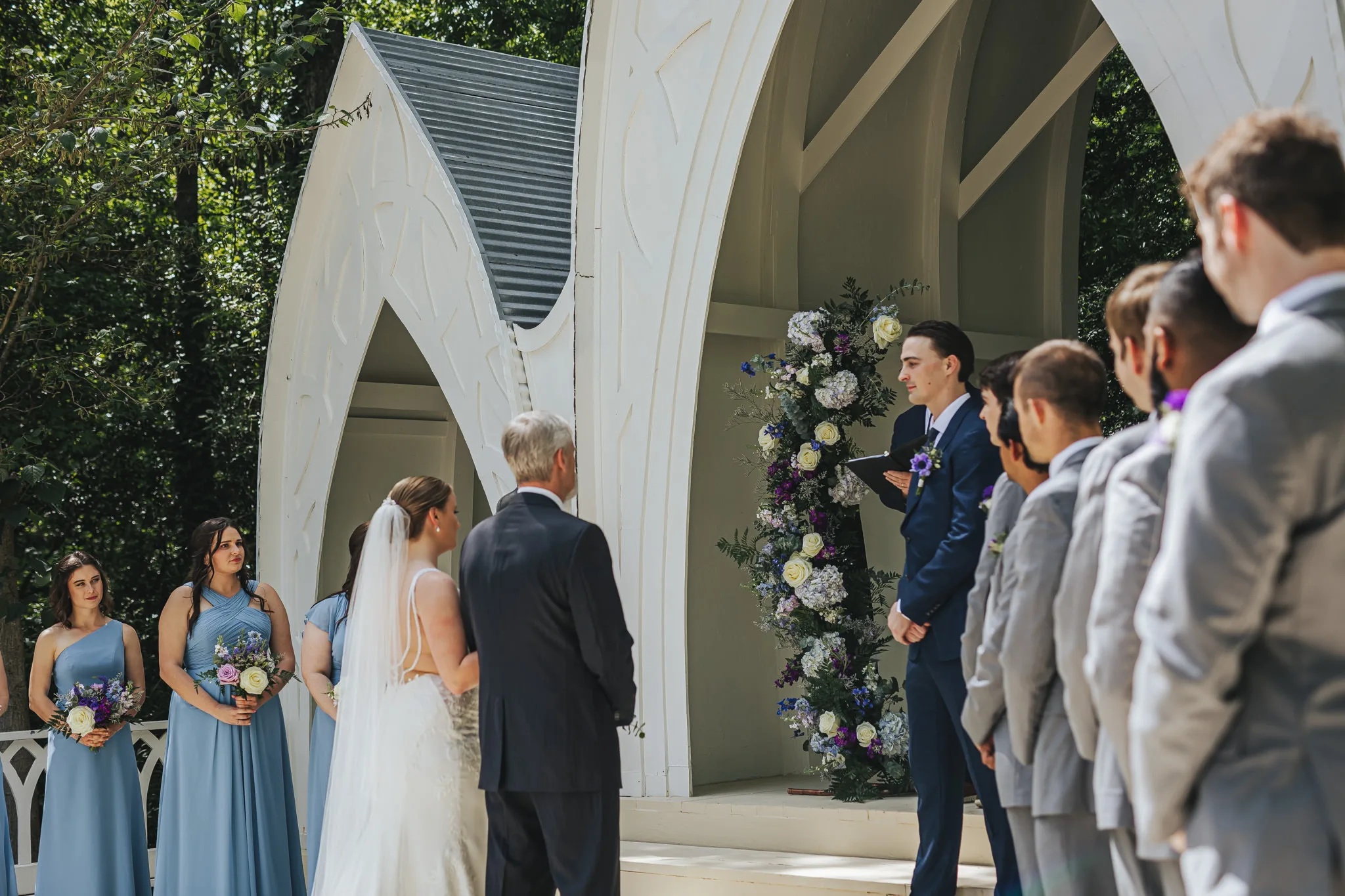 Wedding Ceremony: the bride being given away at the chapel steps, at their wedding at The Wildflower 301 in Greensboro, GA