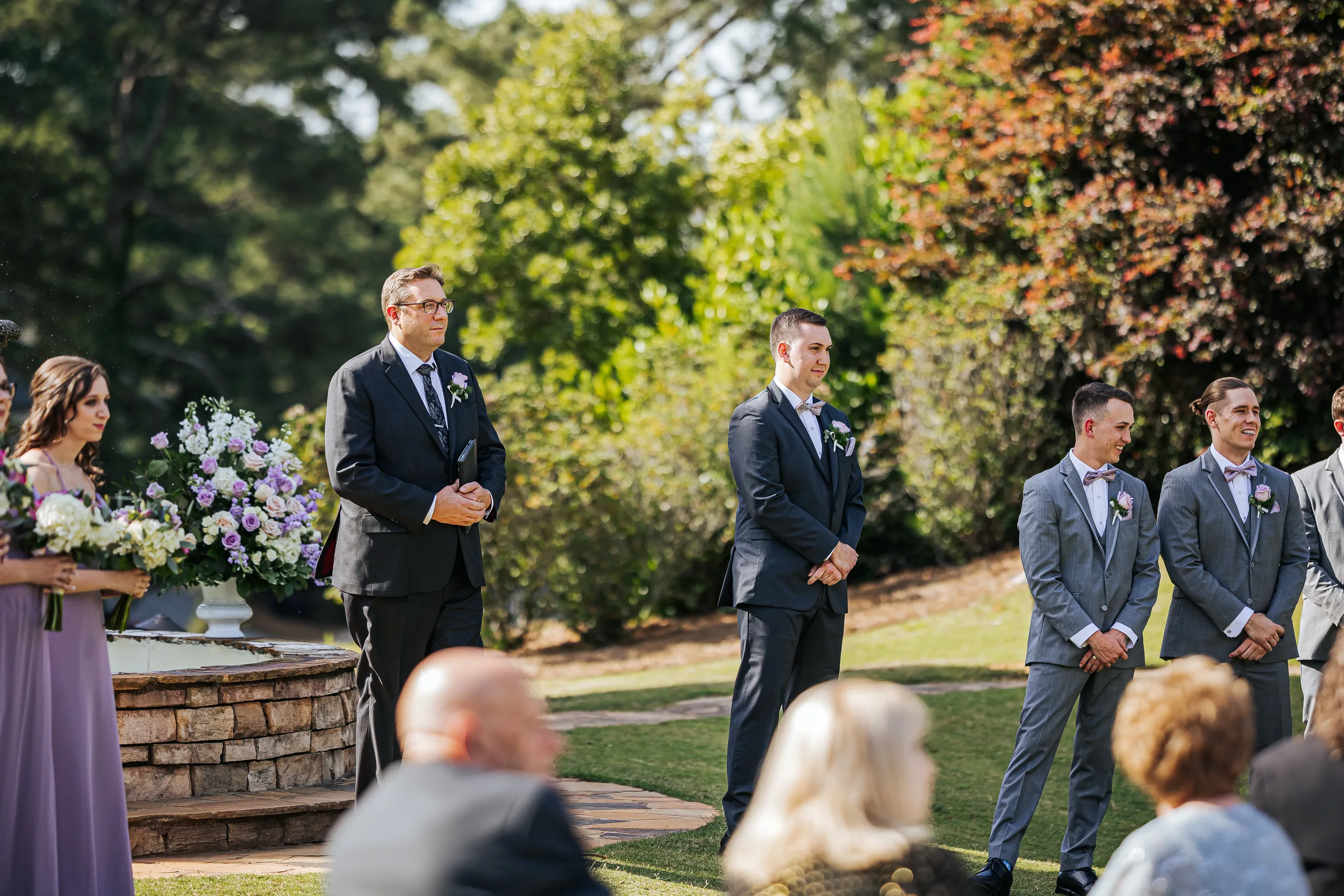 Wedding Ceremony: the groom and his groomsmen waiting on the lawn at their wedding at the Country Club of Roswell in Roswell, GA