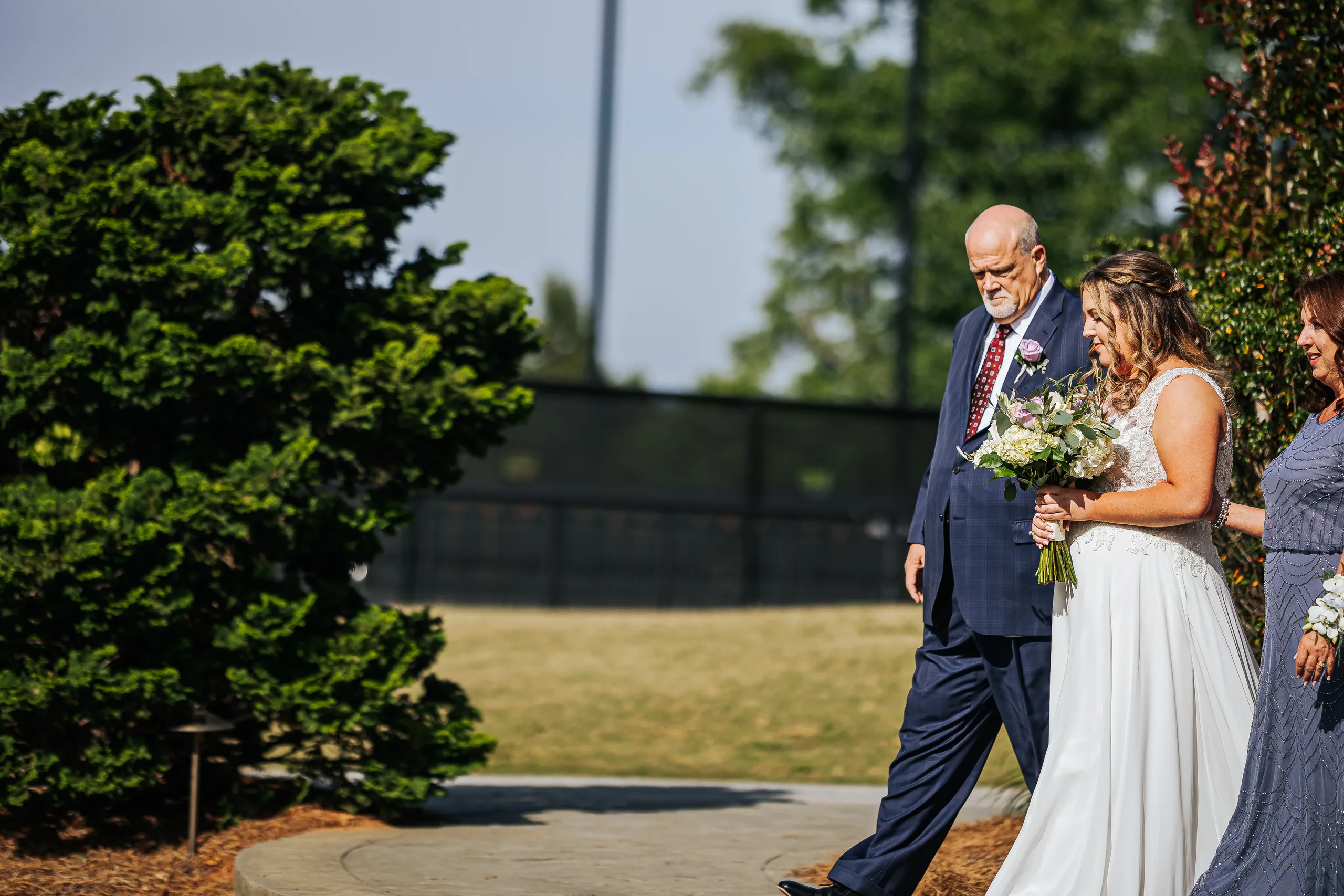 Wedding Ceremony: the bride walking to the ceremony at their wedding at the Country Club of Roswell in Roswell, GA