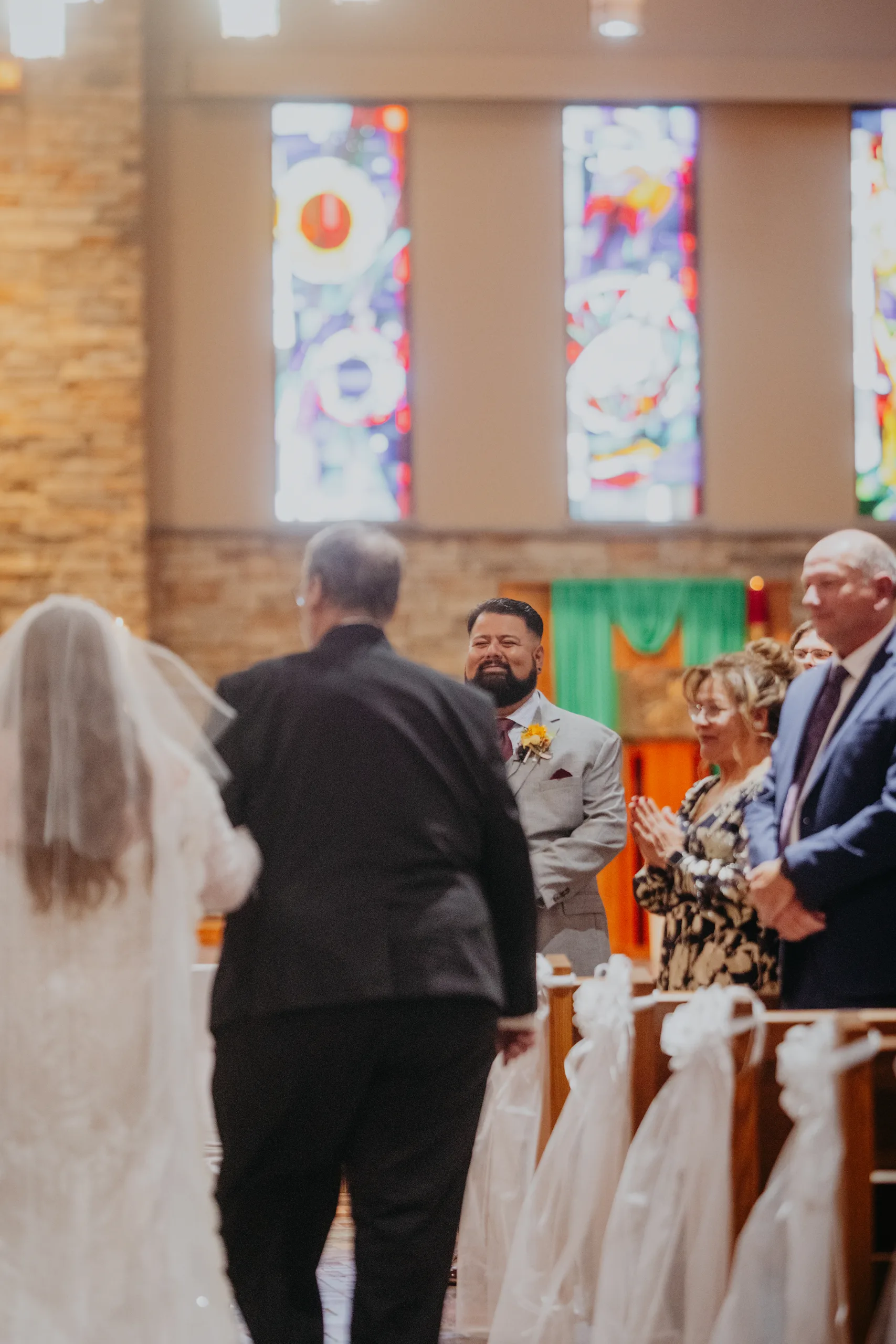 Wedding Ceremony: her dad walking her to the groom at the altar, at their wedding at St. Lawrence Catholic Church in Lawrenceville, GA
