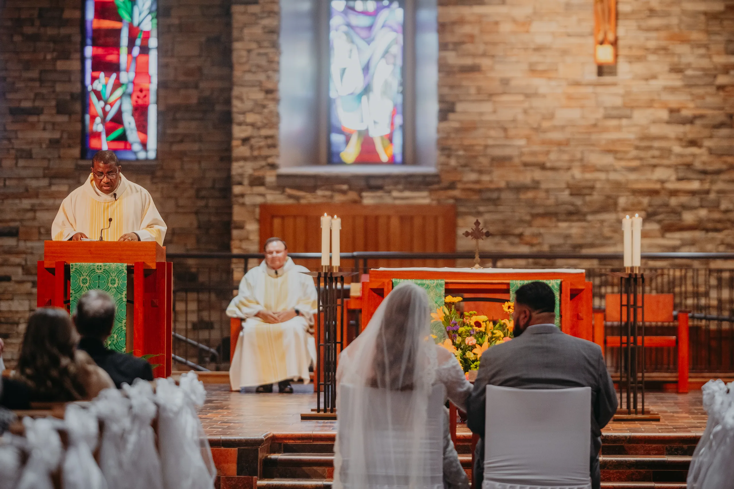 Wedding Ceremony: a reading during the Wedding Mass, at their wedding at St. Lawrence Catholic Church in Lawrenceville, GA