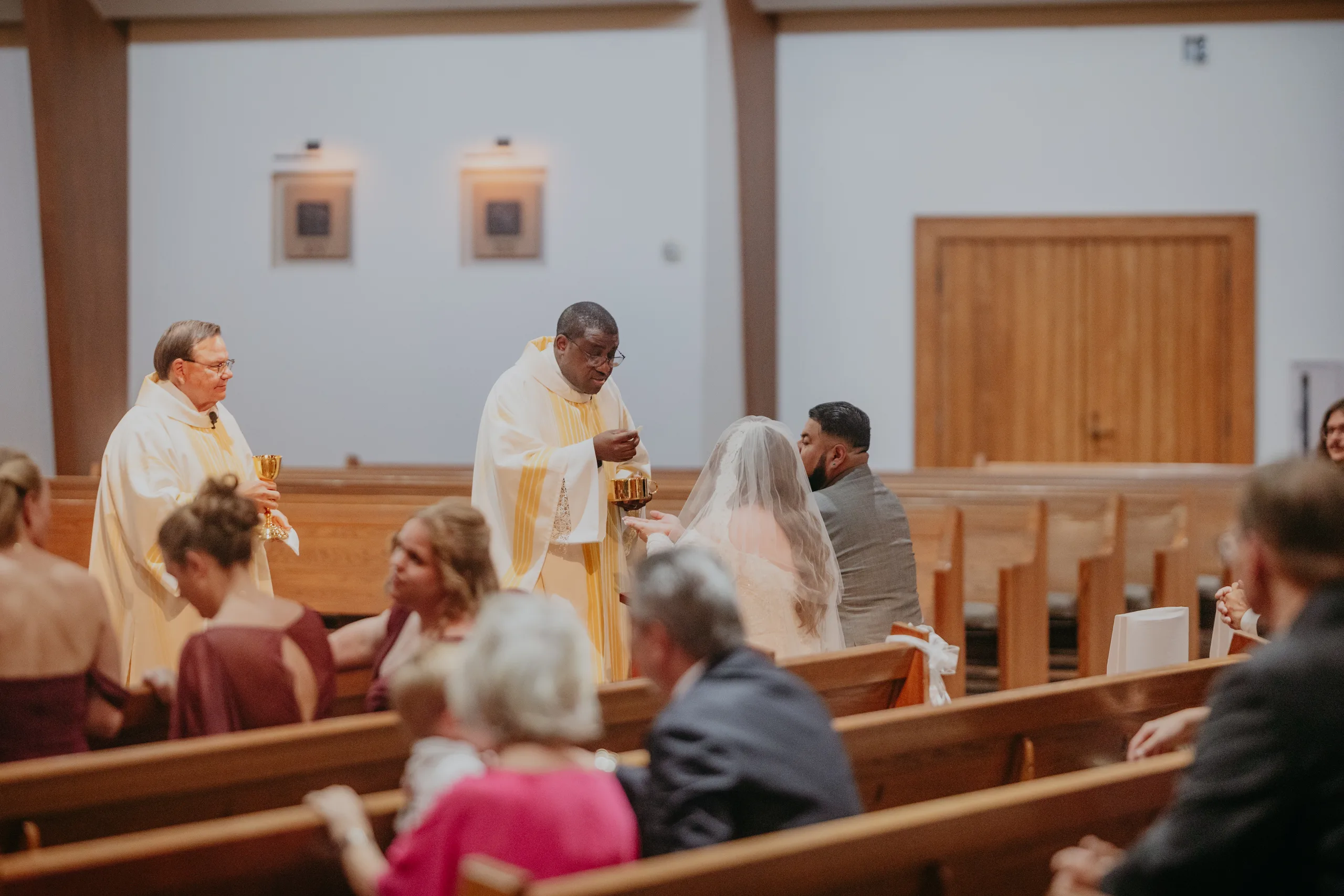 Wedding Ceremony: Communion during the Wedding Mass, at their wedding at St. Lawrence Catholic Church in Lawrenceville, GA