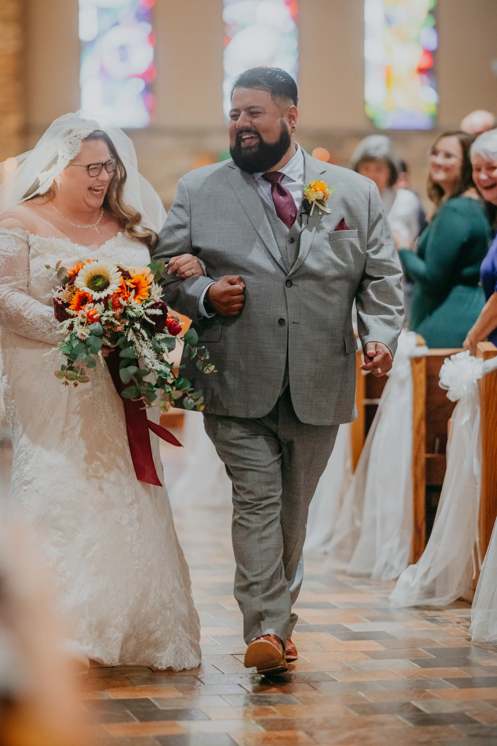 Wedding Ceremony: walking back up the aisle arm in arm, at their wedding at St. Lawrence Catholic Church in Lawrenceville, GA