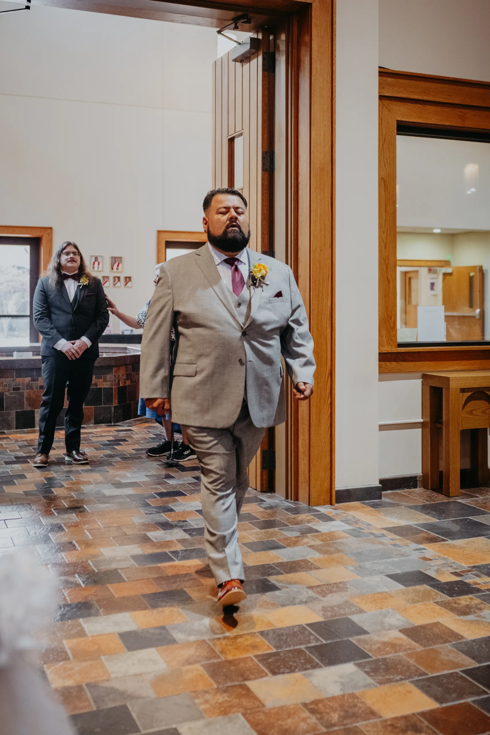 Wedding Ceremony: the groom walking in, at their wedding at St. Lawrence Catholic Church in Lawrenceville, GA