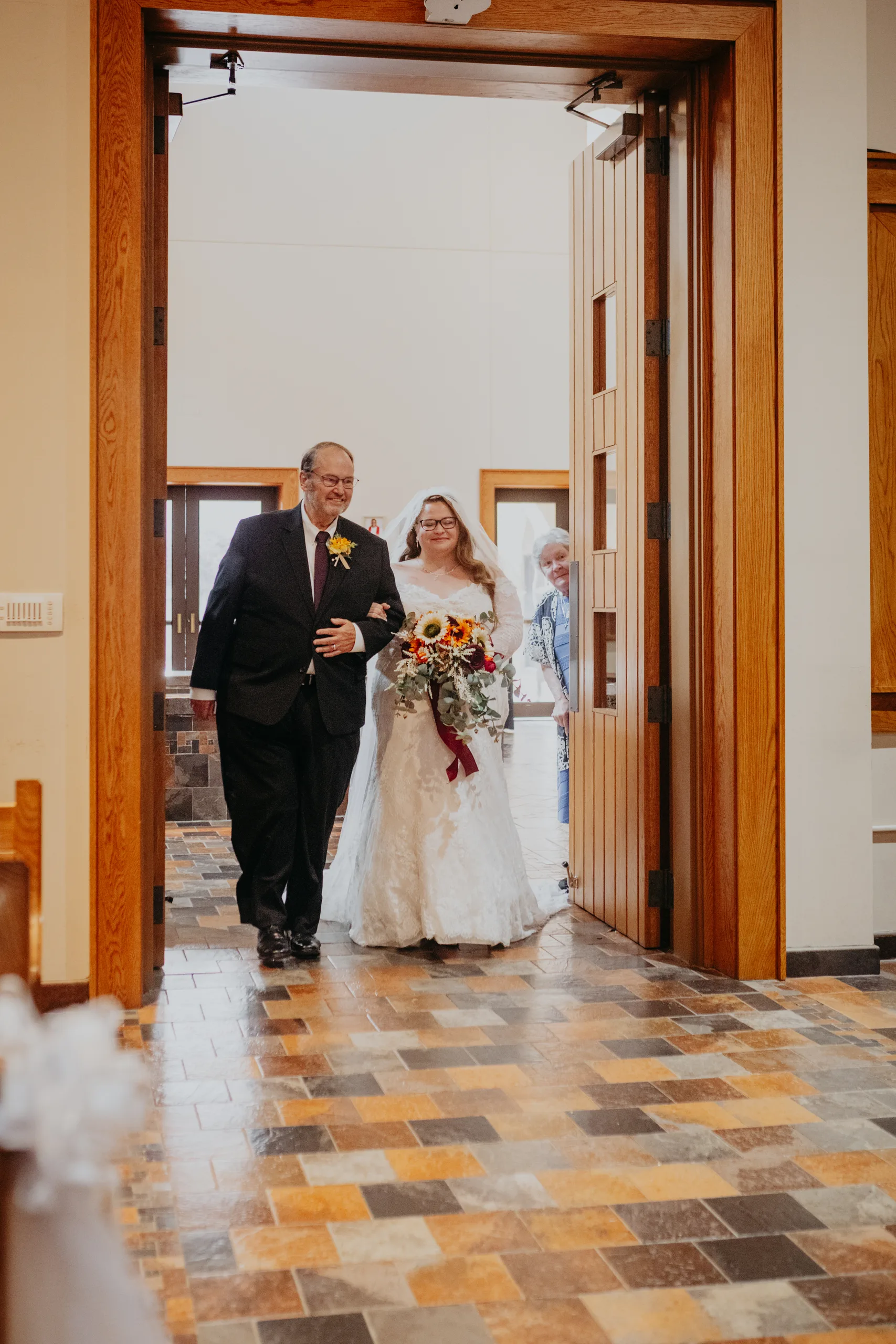 Wedding Ceremony: the bride and her dad at the church doors, at their wedding at St. Lawrence Catholic Church in Lawrenceville, GA