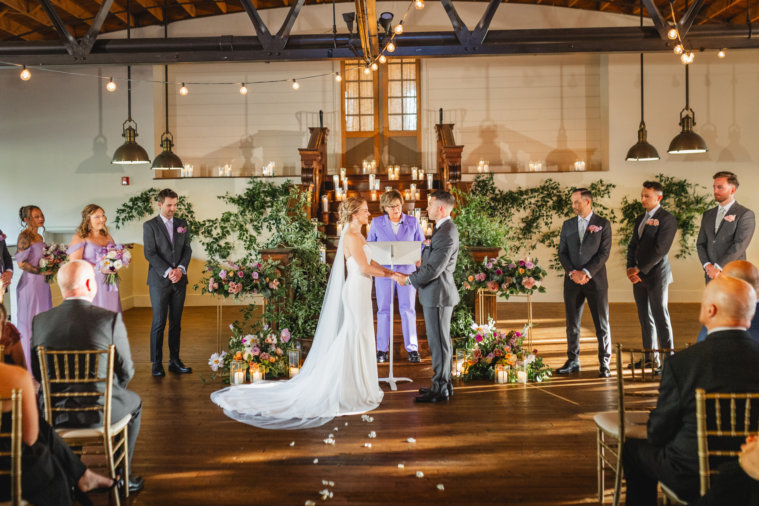 Wedding Ceremony: the two of them holding hands through the vows, at their wedding at Summerour Studio in Atlanta, GA