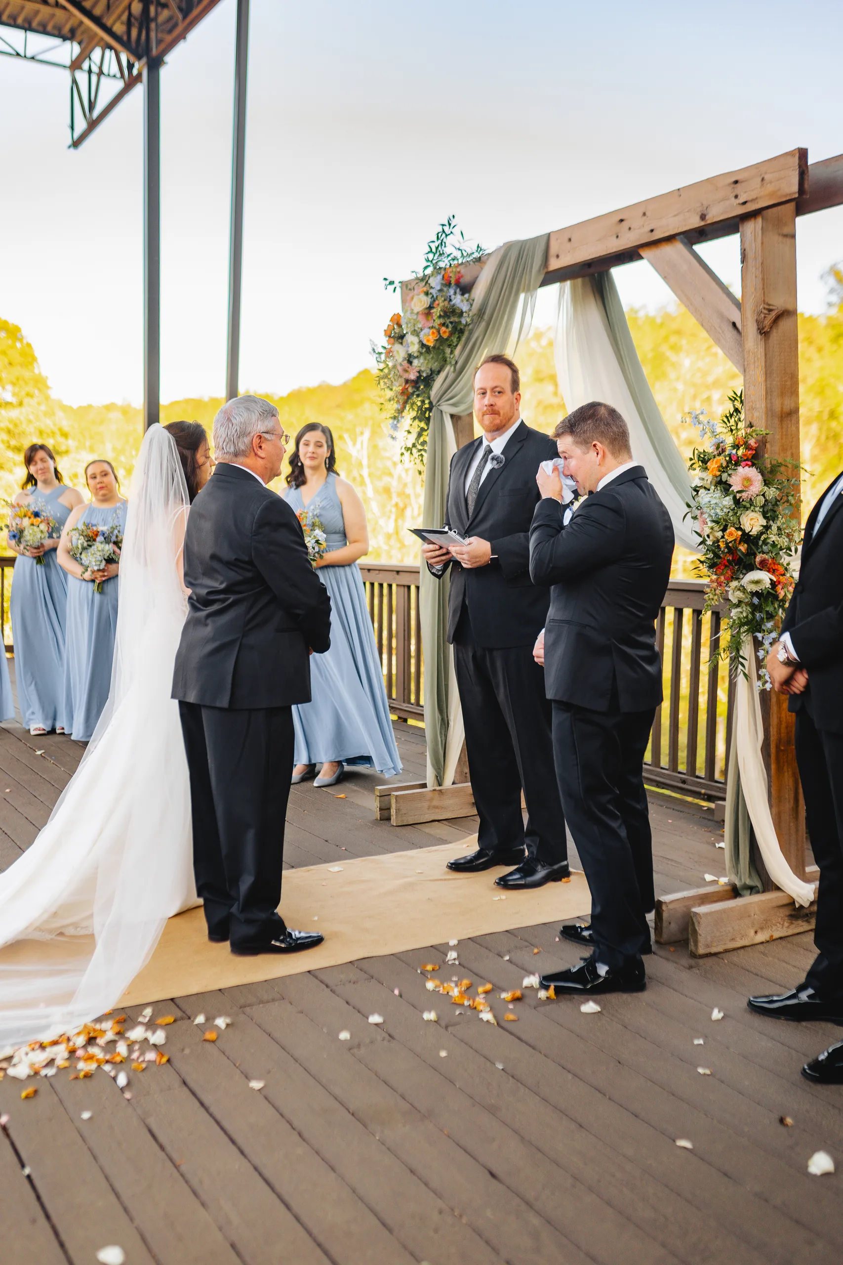 Wedding Ceremony: her dad handing her off to the groom at their wedding at Ivy Hall at Roswell Mill in Roswell, GA