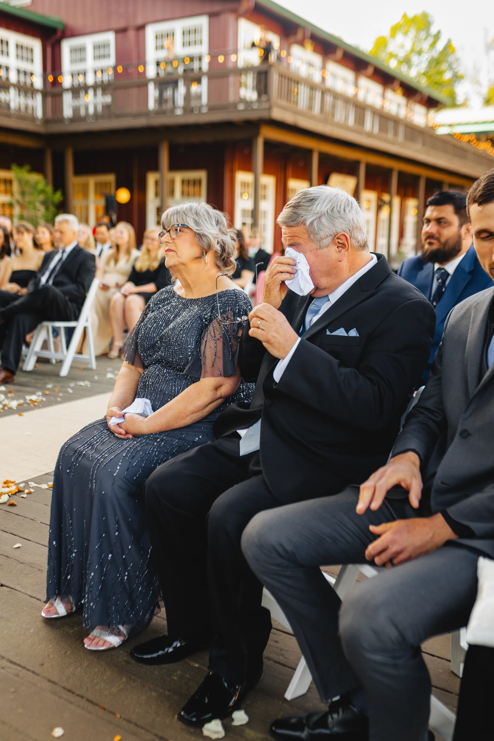 Wedding Ceremony: family in the front row, tissues out at their wedding at Ivy Hall at Roswell Mill in Roswell, GA