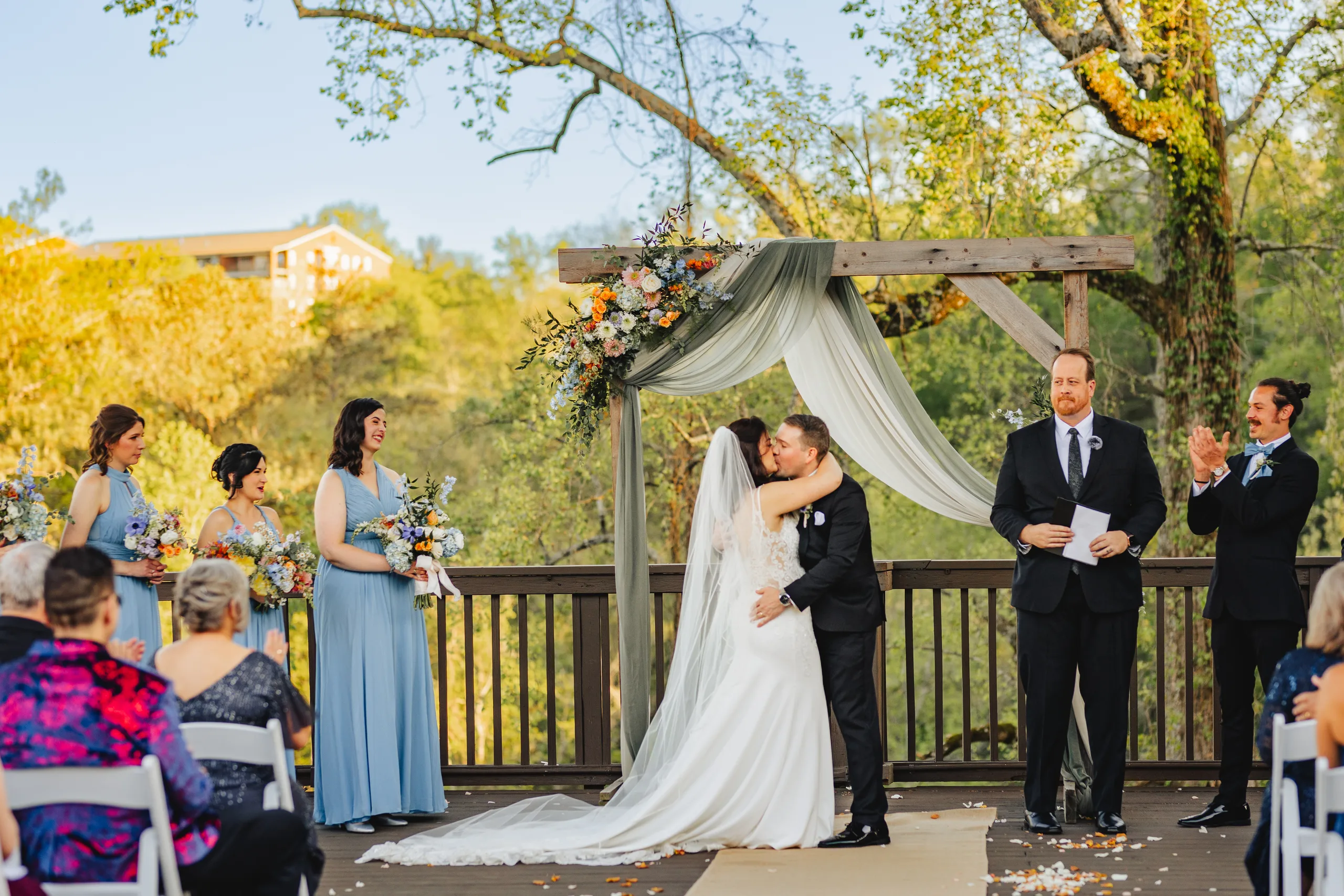 Wedding Ceremony: the first kiss under the arch at their wedding at Ivy Hall at Roswell Mill in Roswell, GA