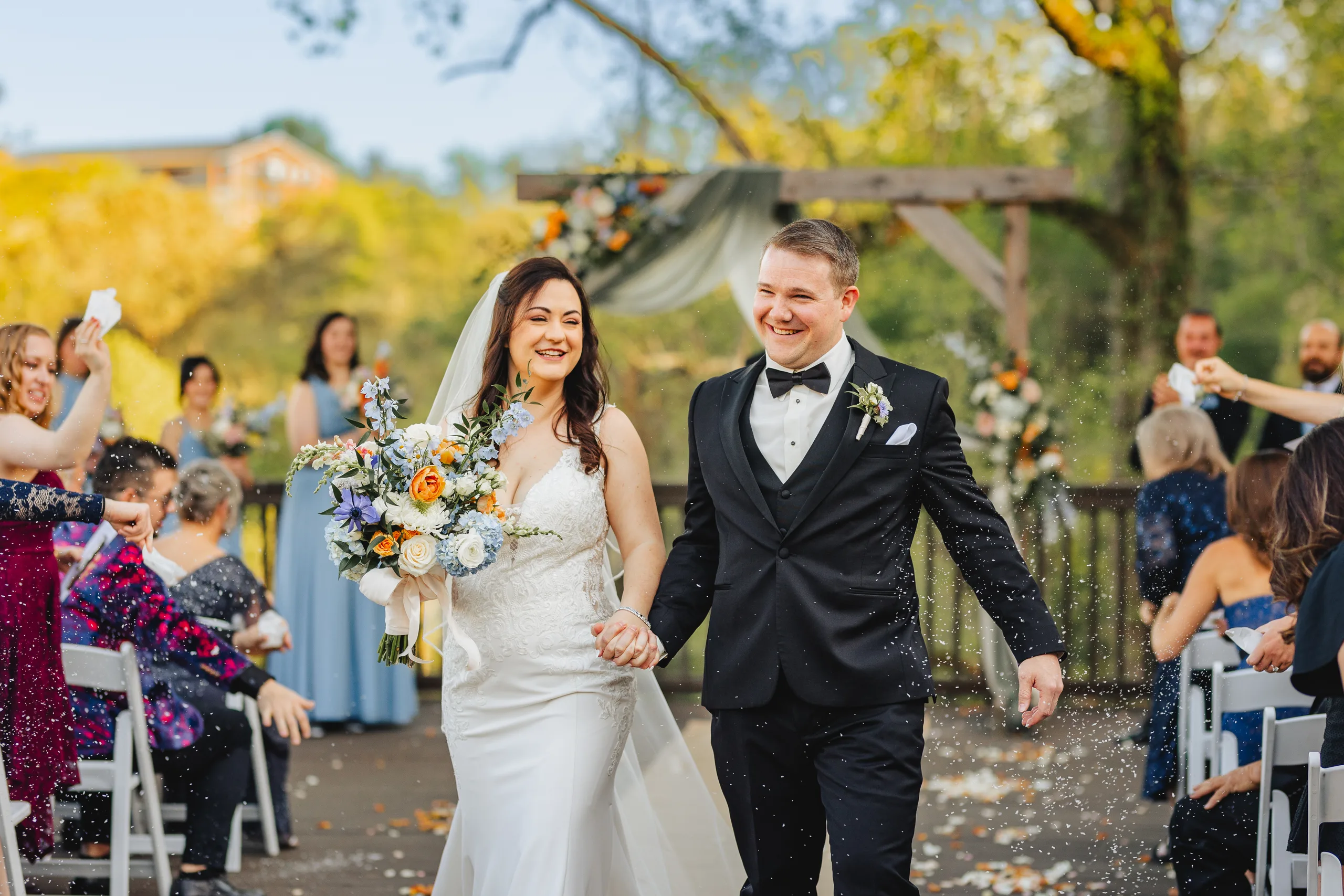 Wedding Ceremony: walking back up the aisle as petals fly at their wedding at Ivy Hall at Roswell Mill in Roswell, GA