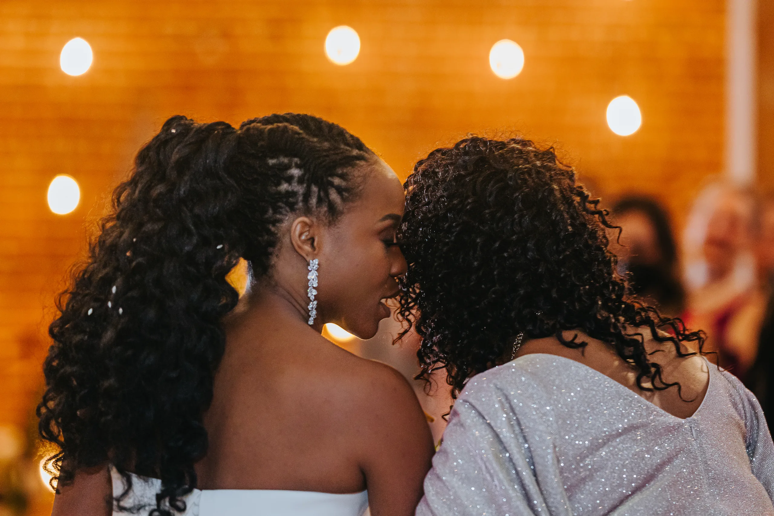 Wedding Ceremony: a kiss on the cheek at the front of the aisle, at their wedding at Terminus 330 in Atlanta, GA