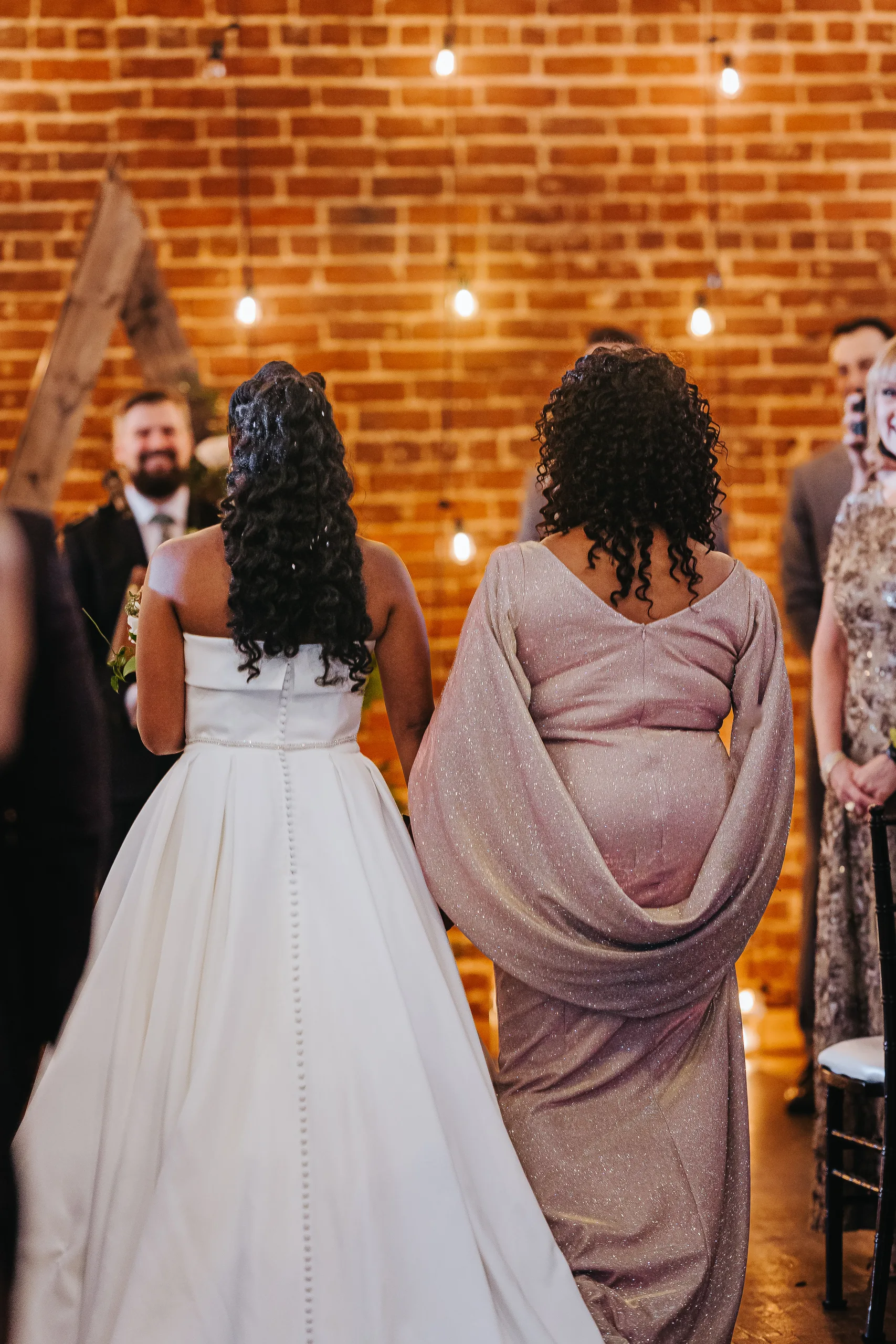 Wedding Ceremony: the bride walking toward the groom, at their wedding at Terminus 330 in Atlanta, GA