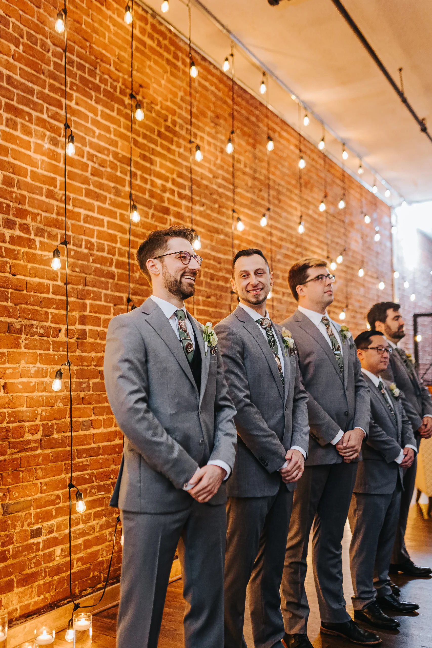 Wedding Ceremony: the groom and his groomsmen waiting in front of the brick wall, at their wedding at Terminus 330 in Atlanta, GA