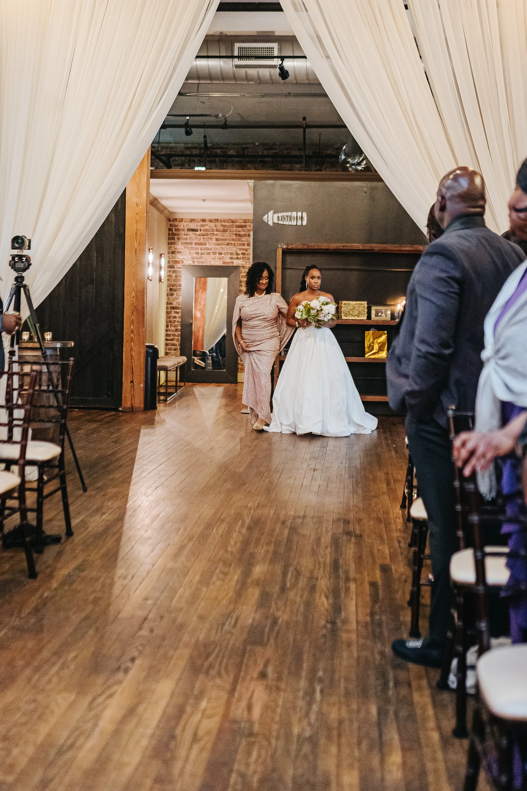Wedding Ceremony: the bride starting down the aisle, at their wedding at Terminus 330 in Atlanta, GA