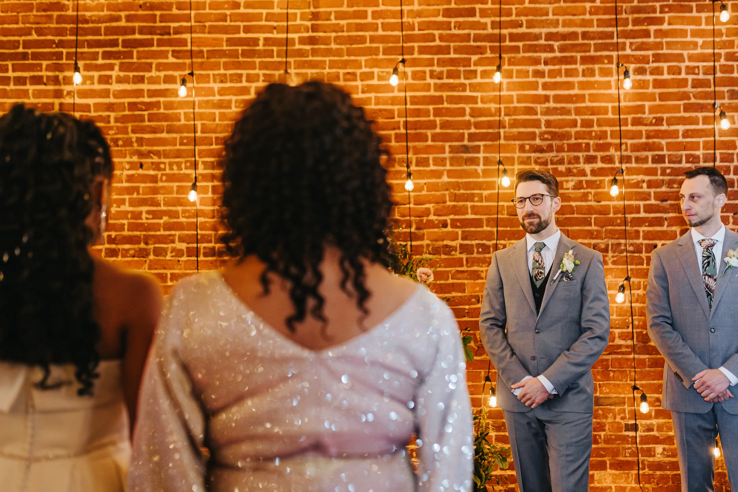 Wedding Ceremony: the groom seeing the bride at the front of the aisle, at their wedding at Terminus 330 in Atlanta, GA