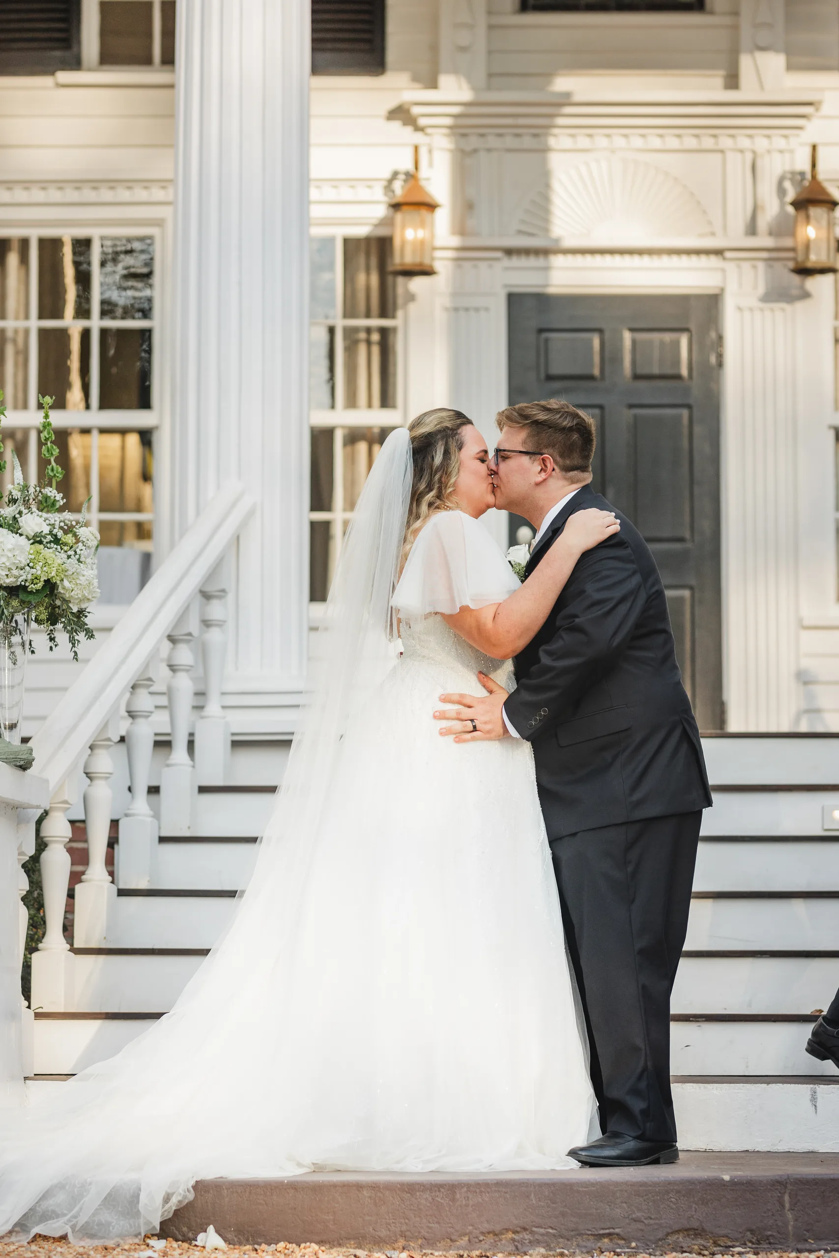 Wedding Ceremony: the first kiss on the front steps, at their wedding at Naylor Hall in Roswell, GA