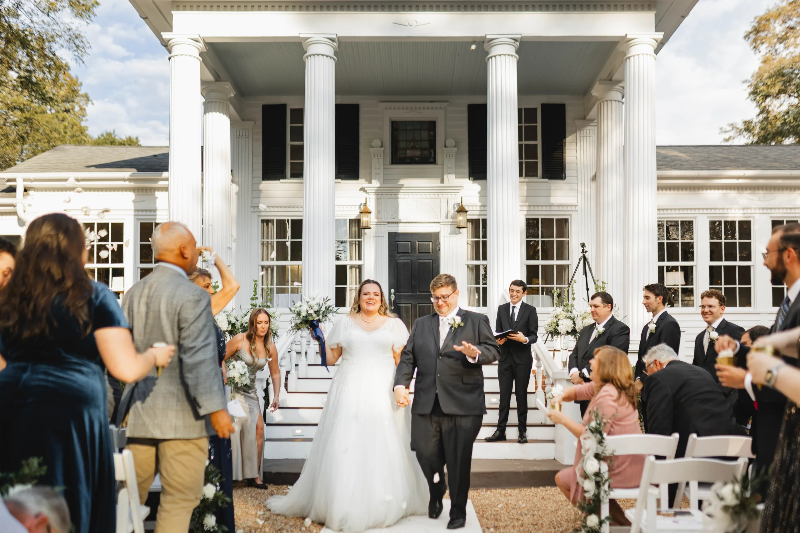 Wedding Ceremony: heading back up the aisle as guests cheer, at their wedding at Naylor Hall in Roswell, GA