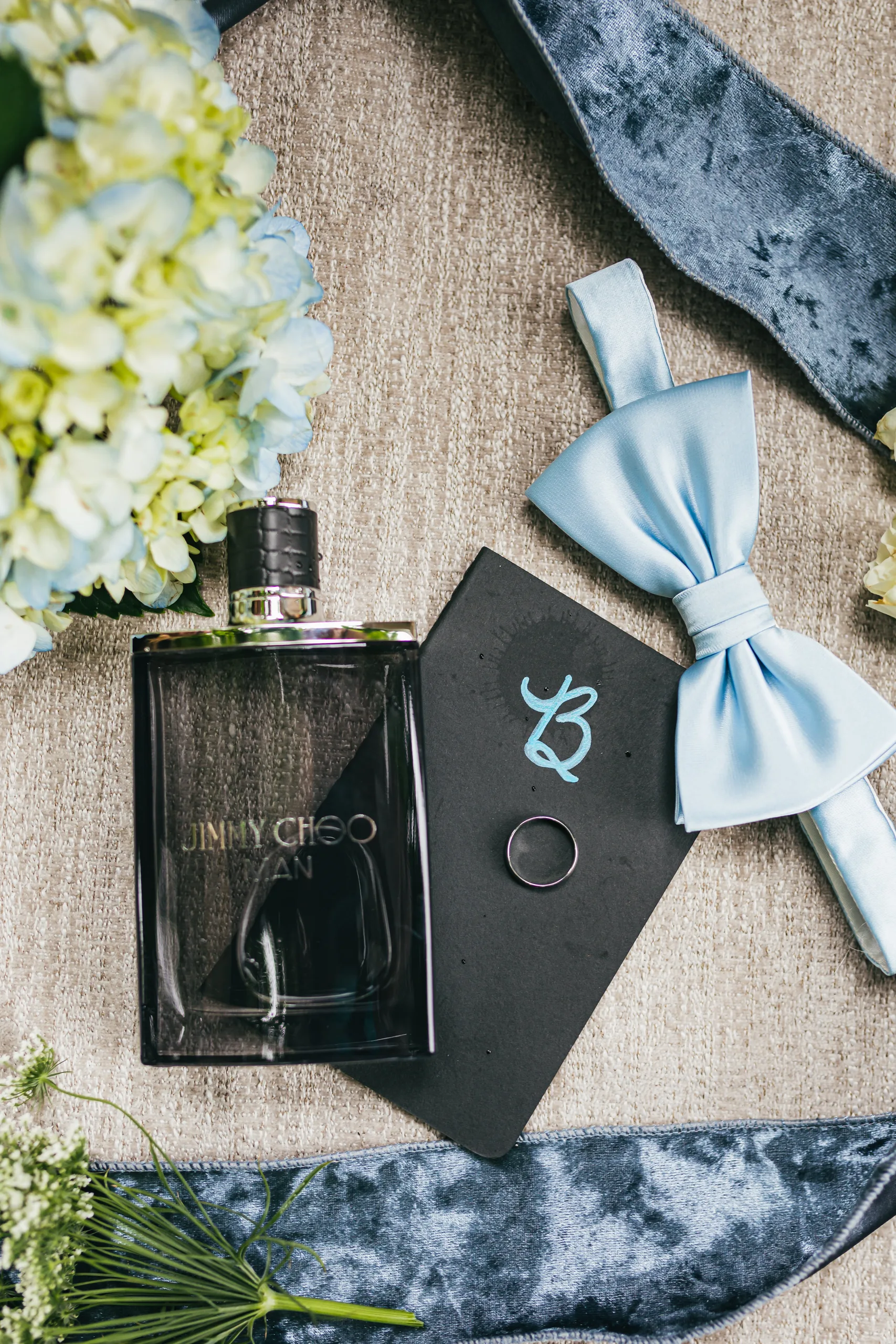 Wedding Details: his cologne, cufflinks and light blue bow tie at a wedding at the Payne-Corley House in Duluth, GA