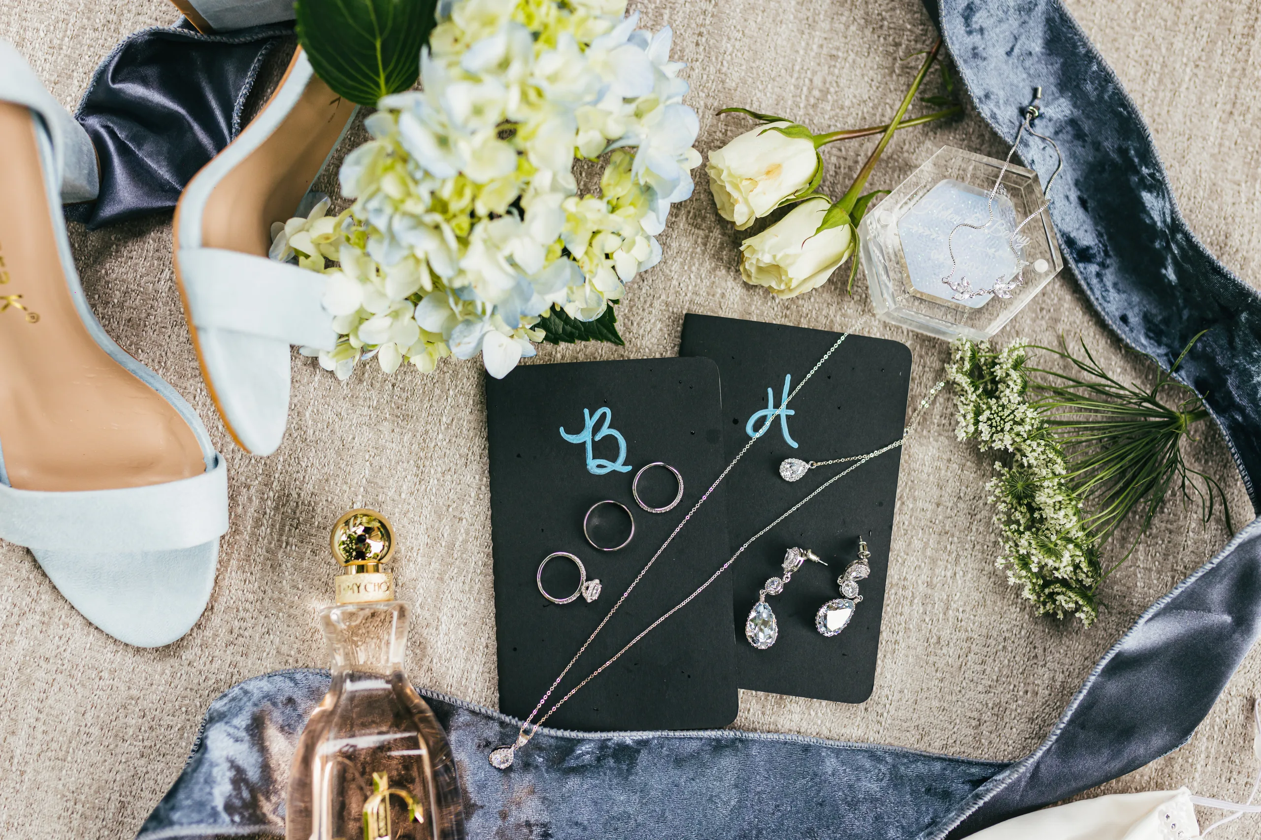 Wedding Details: her shoes, rings, earrings and flowers on navy velvet ribbon at a wedding at the Payne-Corley House in Duluth, GA
