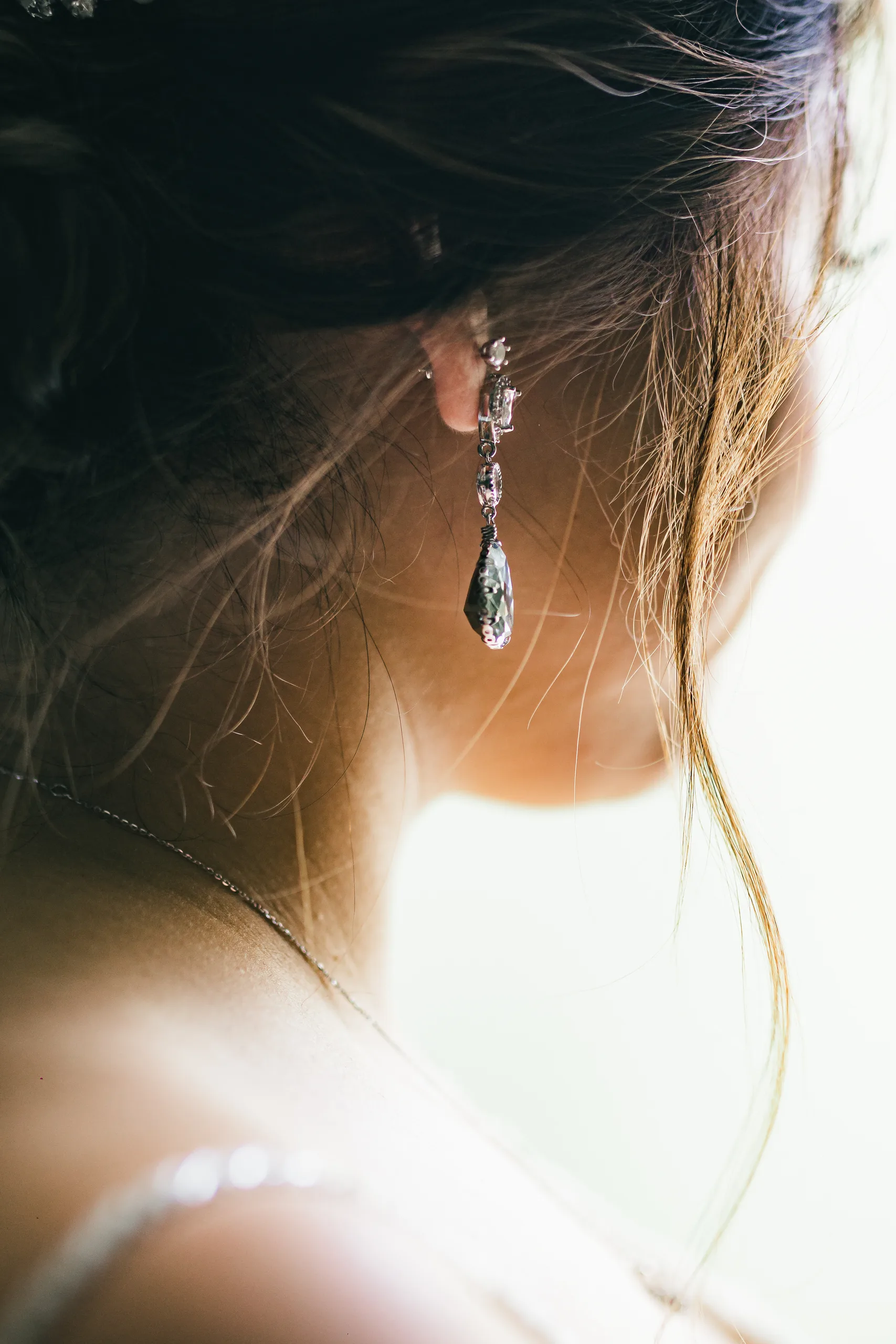 Getting Ready: her drop earring and hair up close before their wedding at Holy Cross Catholic Church in Atlanta, GA
