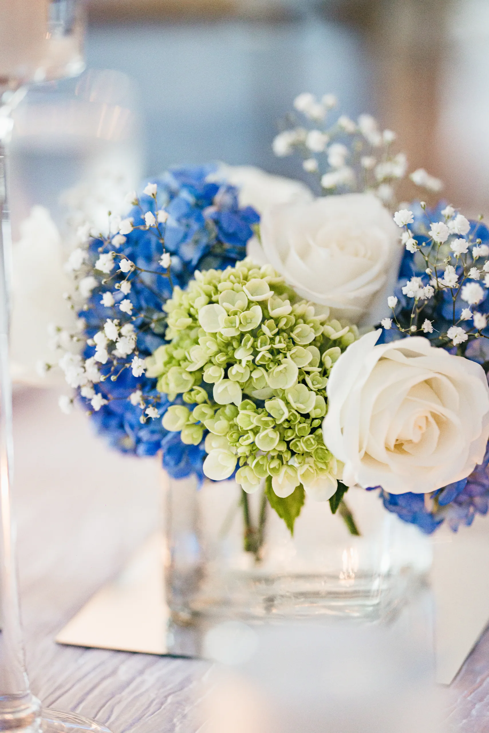 Reception Details: blue hydrangea and white roses up close at a wedding at the Payne-Corley House in Duluth, GA
