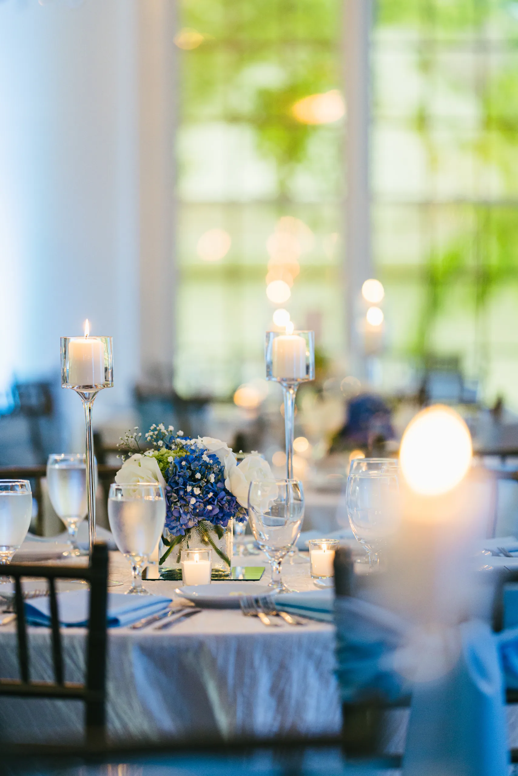 Reception Details: candlelit tables by the window at a wedding at the Payne-Corley House in Duluth, GA