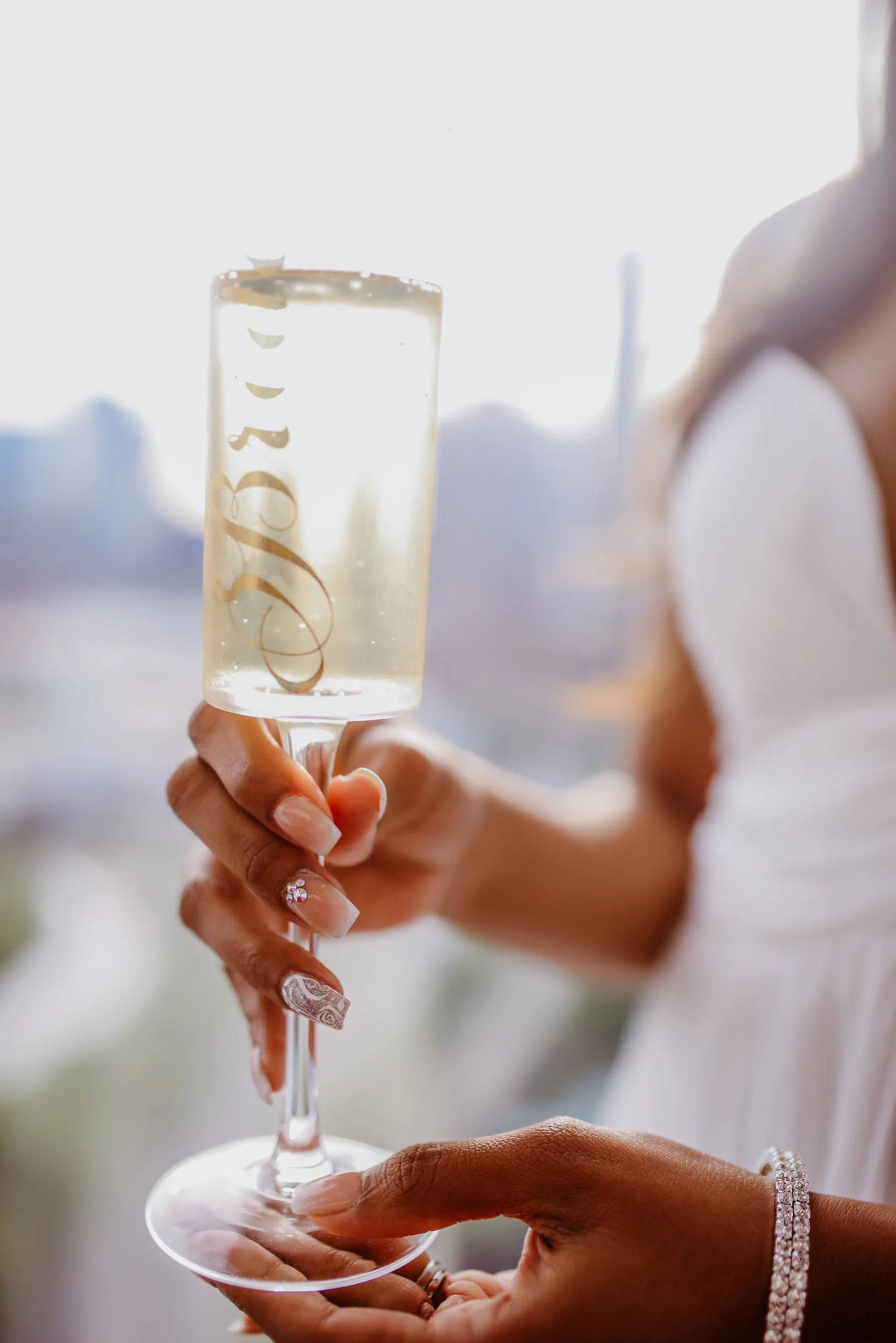 Reception Details: the bride holding a champagne flute that says Mrs, at their elopement at Ventanas in Atlanta, GA