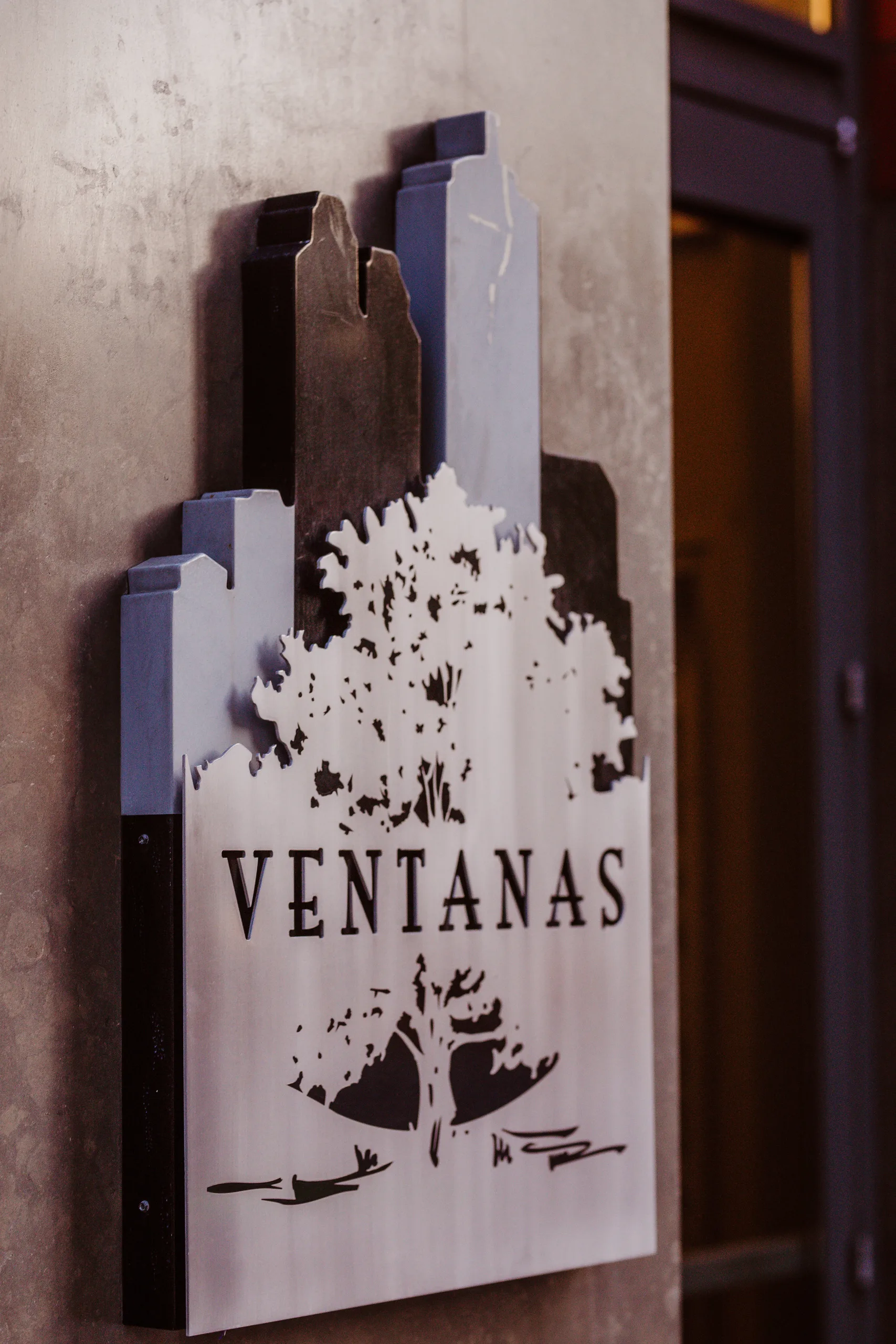 Wedding Details: the Ventanas sign with the city skyline and an oak tree, at an elopement at Ventanas in Atlanta, GA